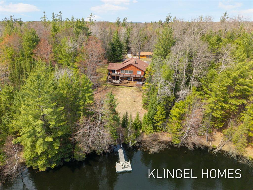 Welcome to 1065 S McMasters Bridge Rd in Grayling! An exceptional log cabin retreat set along approximately 1,000 feet of frontage on the beautiful Au Sable River. This one-of-a-kind property offers the perfect blend of rustic charm and functional living, surrounded by nature and breathtaking water views. The main level features four spacious bedrooms and two full bathrooms, providing comfortable accommodations for family and guests alike. Warm wood finishes and classic log cabin details create a cozy, inviting atmosphere throughout. The fully finished walkout lower level expands your living space with an additional bedroom and full bathroom, ideal for hosting, extended stays, or creating a private guest suite. Step outside and experience true Northern Michigan living with expansive river frontage perfect for fishing, kayaking, or simply enjoying the peaceful surroundings.Whether you're seeking a year-round residence or vacation getaway, this property delivers unmatched charm, space, and waterfront lifestyle! Schedule your private showing today and discover everything this remarkable riverfront home has to offer!