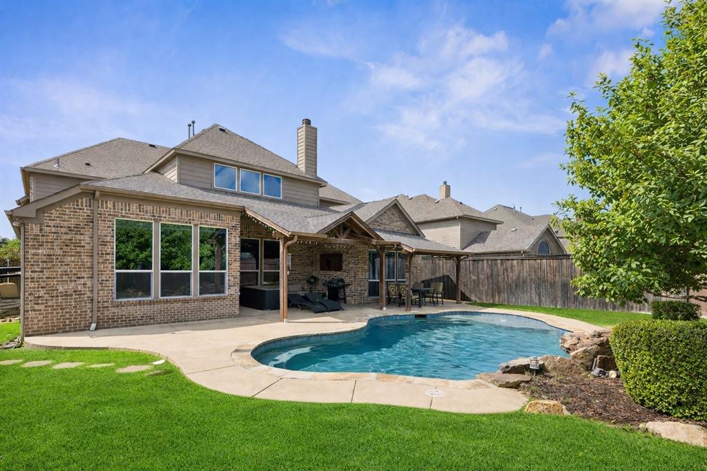 Don't miss this spacious and very well maintained home in Shiloh Lakes offering 5 bedrooms, 4 and a half bathrooms, and a flexible layout designed for everyday living and entertaining. All bedrooms feature walk in closets, with most offering private ensuite bathrooms as well. Two bedrooms are located on the first floor, including the primary suite and a secondary guest room, ideal for multi-generational living, along with a dedicated office great for working from home. The large primary suite offers a prime pool view, a spacious bathroom with dual vanities and sinks, a garden tub, separate glass enclosed shower, and a dedicated makeup vanity. This property includes three living areas with a main living room downstairs, an additional living space upstairs, and a media room that is pre wired for a projector that can also function as a game room or workout space. The gorgeous kitchen is equipped with an island, granite countertops, gas range, oven, built in microwave, disposal, brand new dishwasher, walk in pantry, and breakfast bar, perfect for entertaining. Granite countertops are also found in all bathrooms throughout. Recent updates include a roof replaced in 2022, beautiful new engineered hardwood flooring installed throughout the downstairs in Dec. 2025, new luxury carpeting upstairs 2026, and a new toilet installation in one of the upstairs guest rooms. Plantation shutters are installed throughout, and the home features high ceilings that bring in natural light. The staircase is finished in hardwood, and the garage includes epoxy flooring. The backyard is designed for both relaxing and fun with a beautiful pool and covered outdoor living area with flat screen TV. Move in just in time for summer and enjoy your own private outdoor space! Located in award winning McKinney ISD with convenient access to nearby shopping, dining, and major roads.