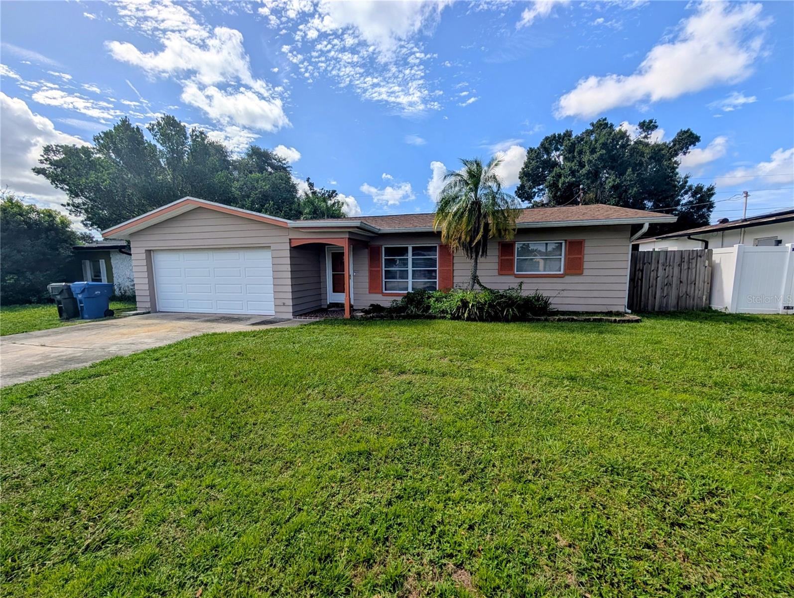 IDEAL STARTER or RETIREMENT block home, built in 1963, with large 2-car garage in NO FLOOD, NO EVACUATION ZONE - a short distance from Largo Mall, schools, restaurants, Police Department, walking distance to Highland Recreational Complex, and only 10 minutes' drive to Gulf beaches! New A/C in 2026, water heater in 2018, shingle roof with gutters (in the back) in 2017, newer kitchen appliances (Bosch dishwasher, Whirlpool oven & refrigerator, Frigidaire range & microwave), storage room or office off the kitchen, closet pantry and plenty of kitchen cabinets, all newer wood-laminate flooring, remodeled bathroom with modern tiles (shower, no tub), cabinet, sink, faucet and fixtures. Sliding doors off the kitchen/dining room open to a lovely screened 120sqft back porch, overlooking a spacious, all fenced yard with 2 gates - perfect for pets and children to safely run and play! Sprinkler system, Lot size: 65x100. OVERSIZED 2-car GARAGE and great parking space on double driveway! This Ranch home has lovely curb appeal! No HOA: check with the City of Largo - Short-term rentals, storage of boats & RV permitted . Home is currently being painted inside! However, don't delay - come, look, and make it your own today!