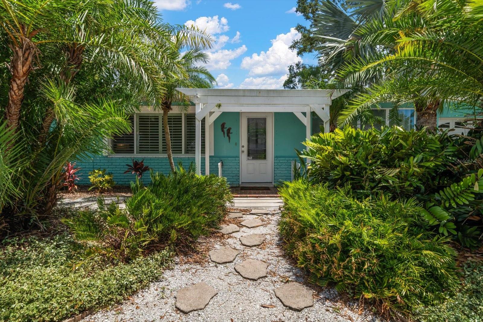 Step into the sunshine and embrace the easygoing Florida lifestyle in this light-filled, beachy bungalow brimming with character and charm. With terrazzo floors throughout, this 3-bedroom, 1-bath home captures the essence of Old Florida while offering modern comfort and versatility.  The spacious kitchen flows seamlessly into the great room, creating an open and airy layout that's perfect for entertaining or relaxing. A bright and cheery Florida room offers endless possibilities—think home office, yoga studio, art space, or cozy reading nook. An additional "beach bath" in the garage adds convenience after outdoor adventures.Step outside to your own tropical oasis with an inviting back patio, covered cabana, outdoor shower, and crushed shell landscaping surrounded by lush native palms. The fully fenced yard sits on a wide lot, with plenty of side yard and driveway space for your boat trailer, extra vehicles, or other toys.Located on one of Dunedin’s coveted brick streets, just minutes from the vibrant shops and restaurants of Downtown Dunedin, and less than 10 minutes to the white sands of Honeymoon Island. Whether you're looking for your first home, a sunny vacation getaway, or a laid-back full-time residence, this Florida gem offers the perfect blend of charm, space, and coastal convenience.NEW ROOF 2026!!