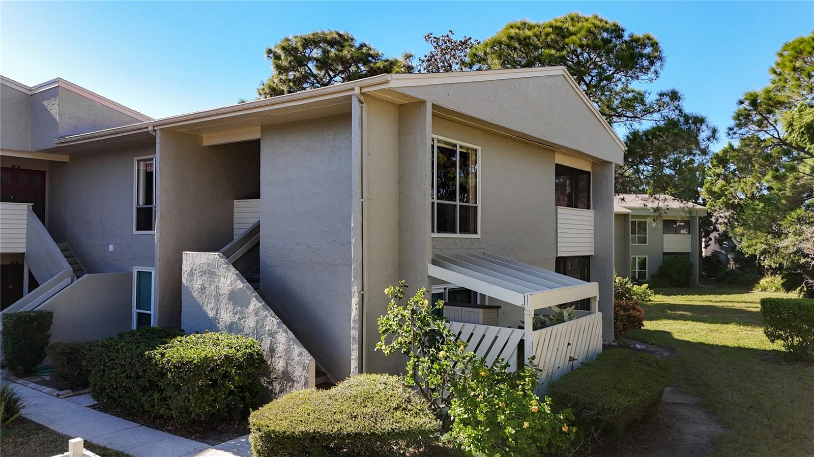 Tarpon Springs -  Windrush Bay -  Welcome to your waterfront all ages retreat in Tarpon Springs, nestled along the beautiful Gulf of America! This well-appointed second-floor condo offers two spacious bedrooms and one full bathroom, making it an ideal maintenance-free winter escape, year-round residence, or income-producing investment. With no flooding or hurricane damage from recent storms, you can enjoy peace of mind while fully embracing the coastal lifestyle. As you enter through the double doors, you’ll find a bright and inviting living area featuring warm tones, laminate floors, and large windows that fill the space with natural light. The updated kitchen boasts white cabinets, elegant marble-look countertops, and black appliances, along with a convenient pass-through bar that seamlessly connects to the dining room. The dining area, highlighted by a wall of windows, creates a light-filled atmosphere perfect for enjoying meals while taking in the beautiful views. Step out onto the screened patio, an ideal outdoor living space for savoring your morning coffee or evening cocktails, all while benefiting from privacy provided by a half wall. Expanding the living space with the sliding doors invites friends and family to gather and share enjoyable moments. The primary bedroom features laminate flooring, a walk-in closet, and generous natural light. The bathroom includes a shower/tub combination, a large vanity, and a separate closet area that houses the washer and dryer. The secondary bedroom also offers laminate flooring, two spacious closets, and a wall of windows that ensures it remains bright and cheerful. Windrush Bay is not just about the individual unit; it’s about the community and lifestyle it offers. Designed for leisure and connection, the community features resort-style amenities including a clubhouse with a fitness room, a billiards table, TVs, a kitchen, and a heated pool. A scenic walking path leads to the Gulf, where you can take in stunning year-round sunsets or relax in the expansive green spaces and community pier. HOA fee includes water, sewer, trash, exterior maintenance, pest control, as well as the wonderful community amenities. Living here means enjoying quick access to the historic sponge docks and downtown Tarpon Springs, along with the beautiful Sunset Beach - an ideal place for evening concerts and sunsets that bring the community together. Whether you’re looking for a seasonal getaway, a full-time residence, or a rental property, this condo at Windrush Bay captures the essence of Florida living, making every day feel like a vacation. Come and experience the peaceful coastal atmosphere of this community - make your private appointment today!