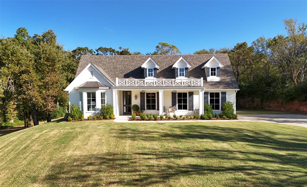 Rare offering in Southeast Edmond. Situated on 1.52 acres, this ultra-private estate property showcases commanding hilltop views of mature trees, verdant foliage, and park-like grounds. Custom-built in 2022, the residence was crafted with incredible scale and attention to detail. Gas lanterns, louvered shutters, and a picturesque covered patio welcome you inside this timeless traditional home complemented by warm contemporary accents. The sophisticated foyer boasts solid wood floors, designer lighting, and breathtaking sightlines of the property’s landscapes. The formal dining room offers an atmosphere of refined elegance. Adjoining the kitchen and dining room, the butler’s pantry features abundant storage, a handcrafted bar sink, and a KitchenAid Beverage Refrigerator/Ice Maker. The gourmet, eat-in kitchen is a culinary enthusiast’s dream, configured with custom inset cabinetry, unlacquered brass accents, KitchenAid Double Ovens/6-Burner Gas Cooktop, pot filler, all centered around a stunning marble-clad island. The living room, surrounded by sweeping treetop views, is anchored by a cast-stone fireplace flanked by custom-built-in bookshelves. The powder bath is chicly appointed with a marble vanity and Schumacher Wallpaper. The secluded primary suite, with private access to the covered patio, provides a tranquil retreat with a spa-inspired ensuite bathroom, and an impressive closet with utility room access. At the opposite end of the home, find two well-appointed secondary bedrooms and a full bath outfitted in elevated finish selections. The utility room is configured with generous storage, a utility sink, and primary bedroom access. Incredible rear covered patio with fireplace, TV, built-in speakers, and unobstructed sight-lines of the scenic surroundings. Additional amenities: Spray Foam Insulation; Sonos Sound System; Visual Comfort Interior Light Fixtures; Solid Red Oak Wood Floors, Marble Tile, and Designer Tile-No Carpet; Epoxy Coated Garage Floor.