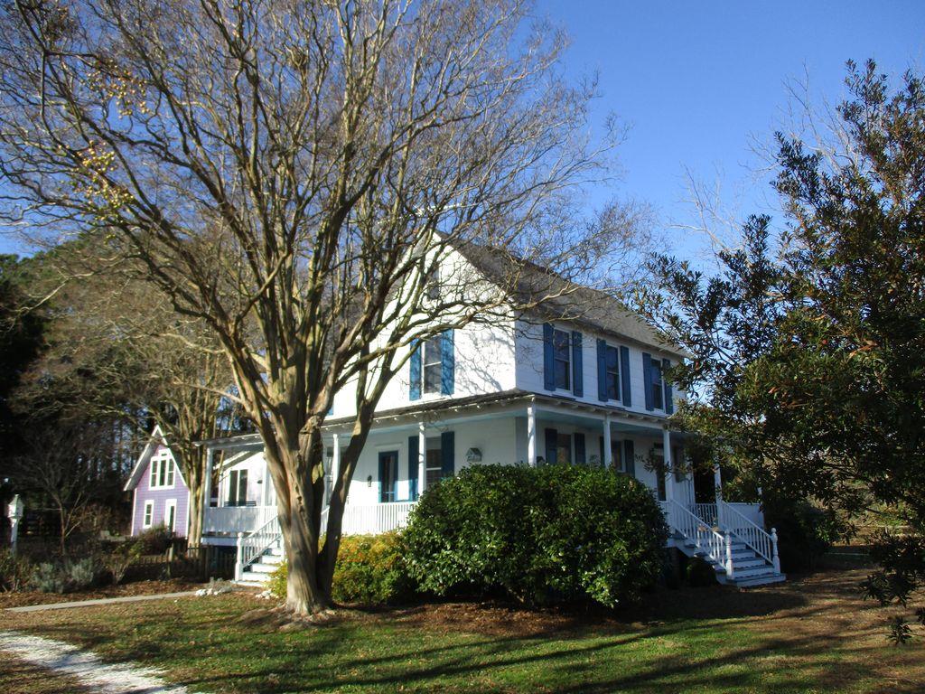 Harbor Rose: Circa 1905. The bayside village of Harborton presents this completely renovated home and artist studio converted into a one-bedroom apartment and woodshop. The rather posh kitchen is open to the family room. Adjacent to the kitchen is the breakfast nook and pantry. Two sitting rooms, one easily converted to a first-floor bedroom, 1 1/2 baths on the first floor, and two full baths on the second floor, along with three bedrooms and an office. While the views over Pungoteague Creek are lovely, the gardens are equally as impressive. The dock has 4' at MLW and a boat lift, multiple slips. The attic is floored, super for storage. Open 3/4 porch conveys views of gardens and sea.