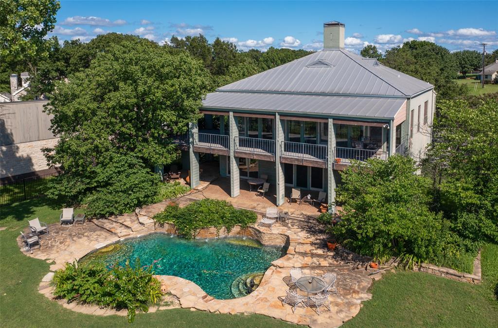 Remarkable, Frank Welch design home with beautiful Lake views. Wood floors throughout, elevator for convenience. Huge porches on both levels breathtaking views. Large open living-dining with fireplace, shelves and wet bar. Gourmet kitchen attached to butler pantry with dumb waiters and attached laundry room. The back yard features a lagoon style pool and a beautiful koi pond.