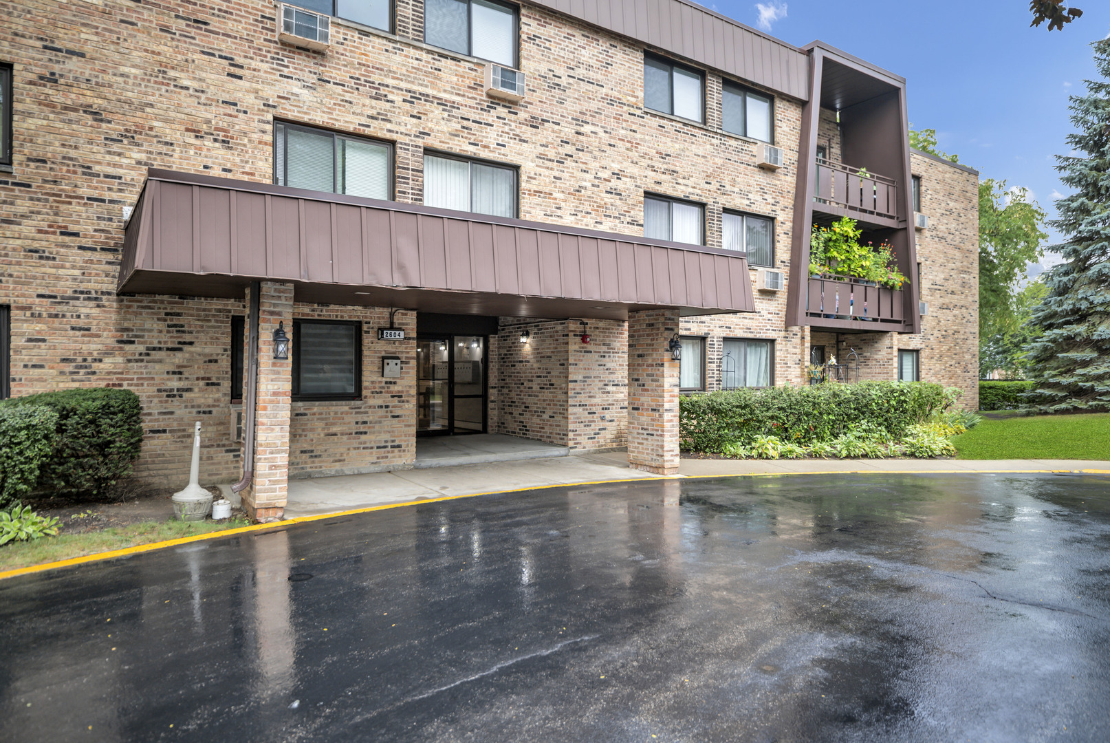 Welcome to this 2-bedroom condo in the desirable Windsor Woods community of Arlington Heights. The spacious living room, filled with natural light, features a slider to the private balcony and flows seamlessly into the dining area. The updated kitchen boasts cherry cabinets with crown molding, stainless steel appliances, granite counters, a breakfast bar, and an additional dining space. The large primary bedroom features a built-in window AC and a private en-suite bath, while the second bedroom and full hall bath are perfect for guests. Relax on the balcony overlooking the professionally landscaped common areas, with shopping, dining, and interstate access just minutes away. A great opportunity in a sought-after location!