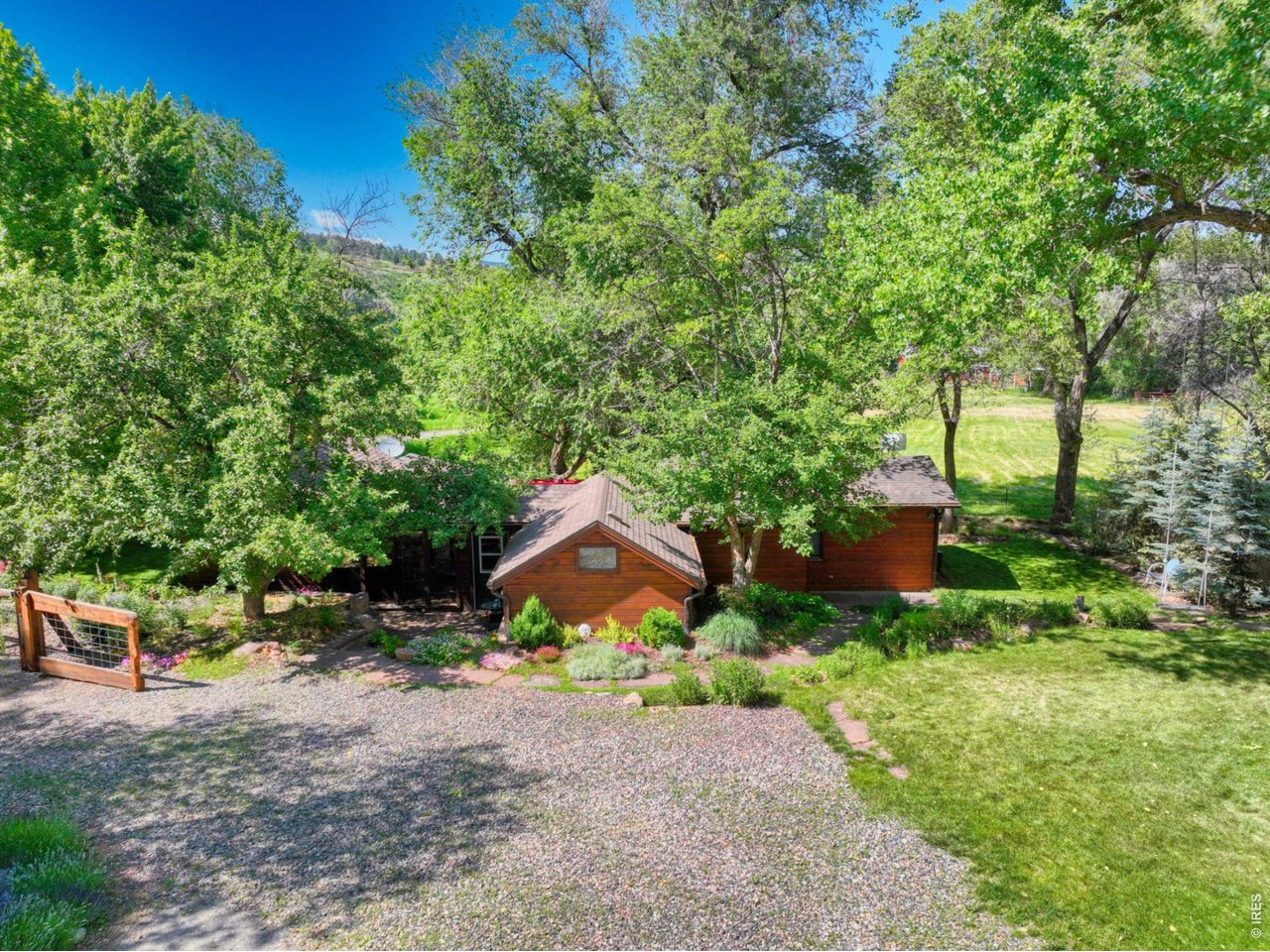 Fabulous location in Lyons! Enjoy peaceful foothill and pastoral views from this charming 2-bedroom, 2-bath home plus office, set on a large, usable .42-acre lot just minutes from trails, parks, and downtown Lyons. Major remodels over time give the home an "effective year built" of 1985, with additional upgrades since 2015! Inside, you'll find a remodeled kitchen, dining area, and bath, along with updated lighting, newer carpet in the living room and bedrooms, and custom built-in closets and dressers. A bright office with a 220-volt outlet offers flexible space for work, hobbies, or a studio, while lovely sandstone accents welcome you in the foyer. Additional improvements include a high-efficiency furnace, two hot water heaters (one tankless), insulated storm windows in the living and dining areas, updated entry and storm doors, and a newer Class 4 roof and gutter system. Enjoy added peace of mind with a high-production well and whole-house water filtration system. Outside, the professionally landscaped yard showcases mature cottonwood and apple trees, winding sandstone paths, a fenced yard with a custom front gate, and a spacious patio-perfect for relaxing or entertaining. With just under half an acre, there's ample room for RV parking, storage or workspace in the two outbuildings, and the potential to expand the home or add a garage. With easy access to nearby trails, open space, and the beautiful St. Vrain River, this property is ideal for nature lovers and recreation enthusiasts alike. Conveniently located with easy access to Lyons, Longmont, Boulder, DIA, and RMNP.