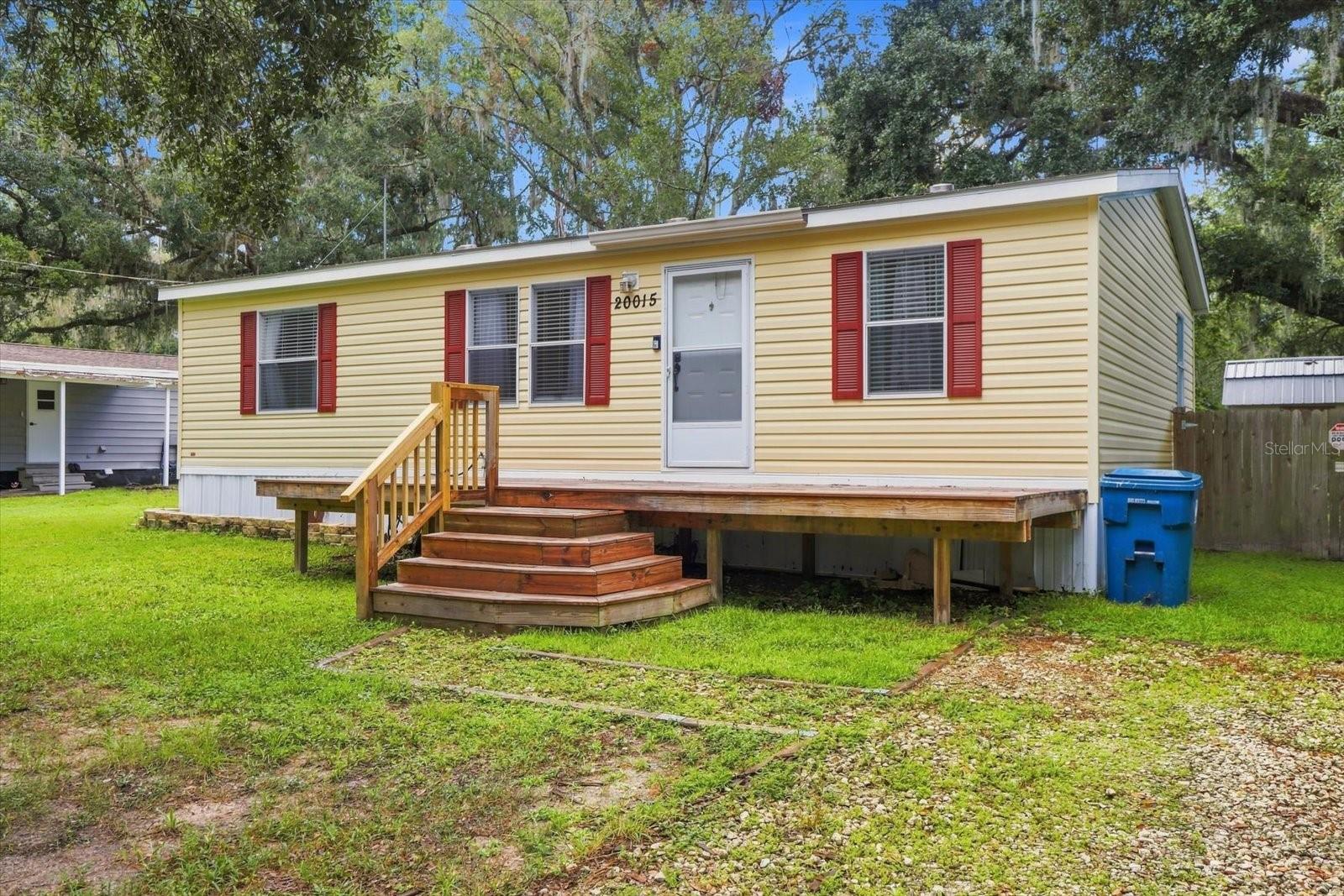 Move in Ready! Beautiful 2020 built manufactured home featuring a spacious split bedroom floor plan with 3 bedrooms and 2 bathrooms. The primary suite offers a walk-in closet and an updated bathroom with a ceramic-tile shower. Enjoy easy-care living with ceramic tile throughout and no carpet. The well-appointed kitchen features a dining area and breakfast bar, opening to a large, comfortable living room—perfect for everyday living and entertaining. Indoor laundry/utility space adds convenience. Step outside to enjoy the covered back deck and fenced yard, including a separate fenced area for pets. The property also includes a chicken coop and shed, both of which convey with the home. A wonderful combination of comfort, functionality, and outdoor space—ready to welcome you home!