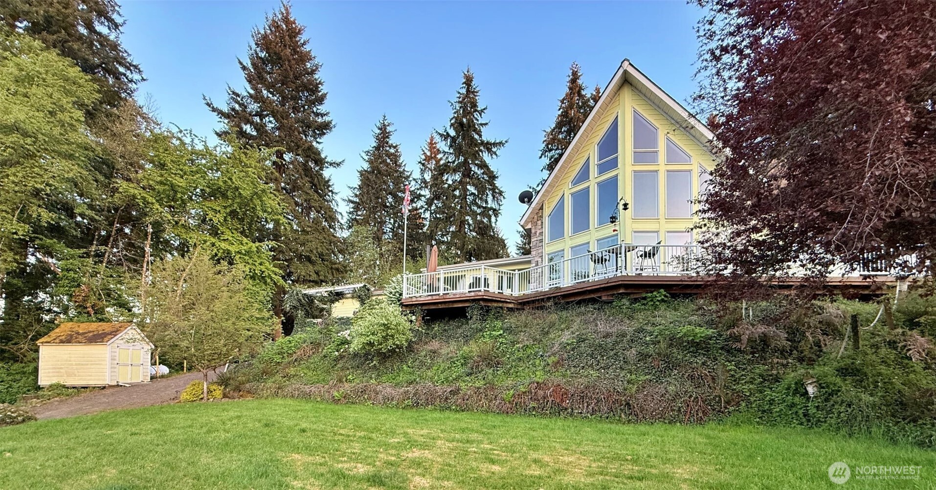 This property features a spacious layout ideal for entertaining, complemented by impressive outdoor decks and a peaceful babbling brook. Additional highlights include a garage, outbuildings for extra storage, and dedicated RV parking for guests. The home is fully connected to sewer, water, and propane services. Gas fireplace in the primary bedroom and living room. Three bedrooms, four bathrooms, one in the garage. Mayfield Lake is great for fishing, boating, and all recreational activities. Bring your golf cart or ATV and head to the lake. The primary bedroom is on the main.