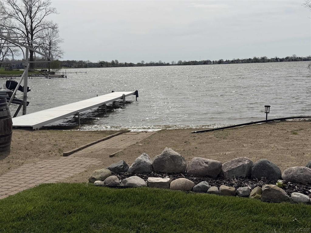 Just over an hour away from Lansing, Toledo, or Ann Arbor this extraordinary waterfront estate invites you to wake up to sweeping panoramic views of Loch Erin from nearly every room. Spanning over 6000 Sq ft., This exceptional retreat is perfectly positioned on a .53 Acre lot with expansive lake frontage. This rare 6 bedroom 4 bathroom home captures breathtaking unobstructed views across the entire lake delivering a truly elevated waterfront lifestyle. Designed for both refined everyday living and effortless entertaining the interior features soaring vaulted ceilings, Expansive skylights that fill the home with natural light, and four fireplaces that create warmth and architectural charm throughout. The thoughtfully designed layout includes 2 luxurious primary suites ideal for multi generational living or hosting guests with comfort and privacy. The finished walkout lower level offers additional living space and entertaining space while the four season room provides a serene setting to enjoy Lakeview's year round. Abundant storage throughout the home ensures both functionality and organization. Outdoor living is unparalleled A sprawling deck overlooks the water creating the perfect backdrop for entertaining, relaxing, or taking in spectacular sunsets. The private beach offers your own personal lakeside retreat while additional storage beneath the deck provides convenient space for all your lake and recreational equipment. Car enthusiast and hobbyists will appreciate the oversized heated garage Complemented by an additional two car garage offering a total of 4/5 garage spaces for vehicles, storage or workshop needs. Adjacent to association owned park the property also enjoys enhanced privacy and open green space further elevating this remarkable setting. -Updates include but not limited to New well in 2021, New furnace and AC in the east wing in 2022, New retaining walls some in 2022 and others in 2024, New lower driveway in 2022, Kitchen update in 2022, flooring update in 2022, Many new Windows and doors, Deck St