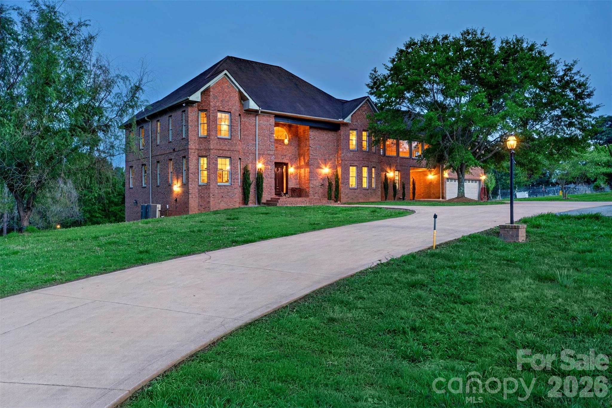 Welcome to one of Upstate South Carolina's most extraordinary private estates, where luxury, land, and lakefront living come together in a way that rarely reaches the market. This property consists of two parcels totaling approximately 12.66 acres — the 2.66-acre parcel on which the home sits, plus an additional 10 acres of adjoining land — both included in the purchase. With direct frontage on Lake Cooley and a gated driveway, this is privacy and prestige at its finest. Built on a 10" concrete slab with steel corner beams and finished with rich hardwood floors throughout, this custom-built masterpiece was designed to last generations. Fresh paint, blinds throughout, and an abundance of natural light pouring through two balconies give the home a bright, move-in-ready feel from the moment you walk in. With 6,368 sq ft of heated and finished interior living space, plus an additional approximately 1,600 sq ft encompassing the garage, patio, and breezeway, the total footprint of this home is nearly 8,000 sq ft. The main level features a spacious layout with two full kitchens — the second a caterer's dream kitchen — ideal for multigenerational living or entertaining. Upstairs, a large sunroom serves as a sun -drenched retreat, and six bedrooms include four with private en suite bathrooms, totaling 6 beds and 6.5 baths. The fully finished basement is a standout feature of its own, complete with a dedicated office, full bathroom, marbled gas fireplace, walkout access to the backyard, and a plumbed-ready area perfect for a bar or third kitchen. The walk-up attic offers exceptional additional space for any need.This home is loaded with premium features including geothermal heating, a whole-home generator, exercise room, workshop, built-in bookcases, jetted tub, and a convection oven. Two fireplaces add warmth and character throughout. Outside, a patio overlooking Lake Cooley sets the scene for unforgettable evenings. The backyard is ready for a swimming pool installation, an outbuilding adds versatile utility, and over 12 private acres stretch right to the water's edge. This is a legacy property. Opportunities like this in the Upstate are exceptionally rare. Schedule your private showing today.