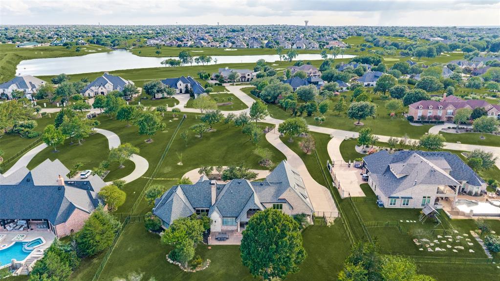Nestled on a rare 2.7 acre private creek lot in the prestigious Gentle Creek Estates community, this extraordinary Prosper estate offers an unmatched combination of privacy, elegance, and natural beauty. Perfectly positioned along the serene banks of Wilson Creek, this custom home is a true showcase of refined living. Step inside to soaring ceilings, extensive hardwood floors throughout, and walls of windows that bathe every room in natural light while framing breathtaking views of your backyard paradise. The gourmet kitchen is a chef's dream, featuring a gas cooktop, built-in refrigerator, ice maker, and abundant custom cabinetry, all flowing seamlessly into the family-sized breakfast nook and the exquisite family room designed for both intimate evenings and grand entertaining.This 6,185 square foot masterpiece includes 5 spacious bedrooms, each with its own ensuite bathroom, plus 2 luxurious half baths, a formal dining room, an executive office with a large work closet, play room, and a massive game room. The private master retreat is a sanctuary unto itself, complete with a generous sitting area, a spa-inspired bath, and his and her closets. Outside, a secluded gated entry with a circular driveway welcomes you home. Enjoy a covered patio perfect for outdoor dining, the peaceful backdrop of your own private creek, and a water well for irrigation. A spacious 4-car garage and 2.70 acres of beautifully maintained grounds provide room for everything and everyone.Located in the highly sought after Gentle Creek Estates golf course community and served by Prosper ISD, including Walnut Hill High School, this home delivers the ultimate in Texas luxury living. If you've been searching for privacy, prestige, and perfection, your search ends here. Schedule your private tour today.