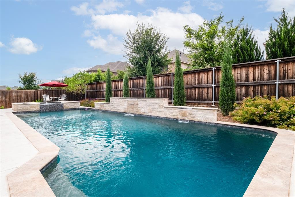 Step into luxury with this stunning home boasting soaring ceilings and an open floor plan, perfectly designed for modern living. The spacious family room welcomes you with its grandeur, complemented by an abundance of natural light and a seamless flow into the amazing kitchen.
Chef-inspired kitchen featuring Stainless Steel appliances, generous counter space, and a center island ideal for gathering.5 bedrooms offer ample accommodations, including a luxurious primary suite retreat with spa-like amenities. The primary closet is a fashion enthusiast's dream, measuring at 15x8 and shelves above and below rods. For recreation discover the expansive game room and media room, providing endless entertainment possibilities for family and guests. Step outside to your private oasis, a beautiful swimming pool with spa, shear descent waterfalls and lush landscaping. 3 car tandem with epoxy coated floors.****Second bed and bath floor plan was offered when built. Shower can be added to powder bath.
