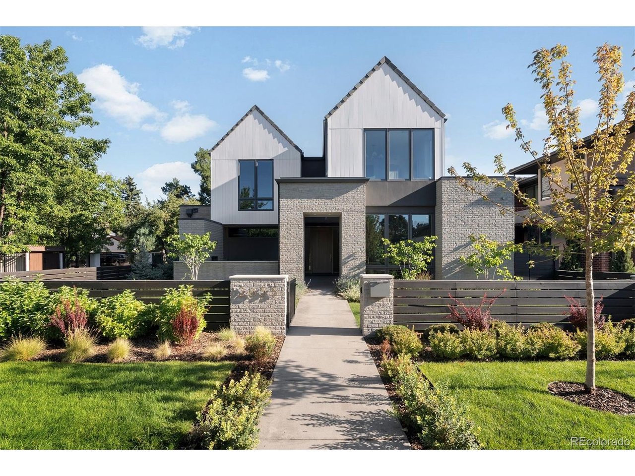 In one of Denver's most exclusive enclaves, this newly built estate rises as a statement of architectural artistry and modern indulgence. Spanning more than 8,500 square feet, it is more than a home; it is a private sanctuary where elegance, comfort, and prestige converge at the highest level. The kitchen is a true showpiece, designed as both a chef's dream and an entertainer's stage. Professional-grade Thermador appliances complement an Matarazzo Marble waterfall island and full backsplash, while a nearly 100-bottle wine column and hand-finished White Dove oak cabinetry elevate every culinary moment. The formal dining room flows gracefully to the covered patio and lush backyard, while the great room commands attention with a soaring Marble fireplace and Nano doors that dissolve the boundary between indoors and out, creating a seamless resort-like retreat. The west wing primary suite defines sophistication, with a private balcony overlooking the grounds, a fireplace for intimate evenings, and a spa-inspired bath with dual vanities, sculptural freestanding tub, oversized shower, and a couture-level custom closet. A luminous loft separates this haven from three additional en-suite bedrooms, ensuring privacy and comfort for family and guests alike. The lower level transforms leisure into an art form, with a refined lounge and wet bar, a climate-controlled wine room, a glass-enclosed fitness studio, a state-of-the-art golf simulator, and a secluded guest suite that offers the ultimate in comfort. Set on a manicured 10,167 square foot lot, the estate is enhanced by an oversized three-car garage and professional landscaping. Just moments from Cherry Creek's designer boutiques, acclaimed dining, galleries, and cultural experiences, this address combines the best of Denver living with the rarity of brand-new construction. 2655 E. Cedar Avenue is not simply a residence; it is a legacy estate crafted for those who expect nothing less than extraordinary.