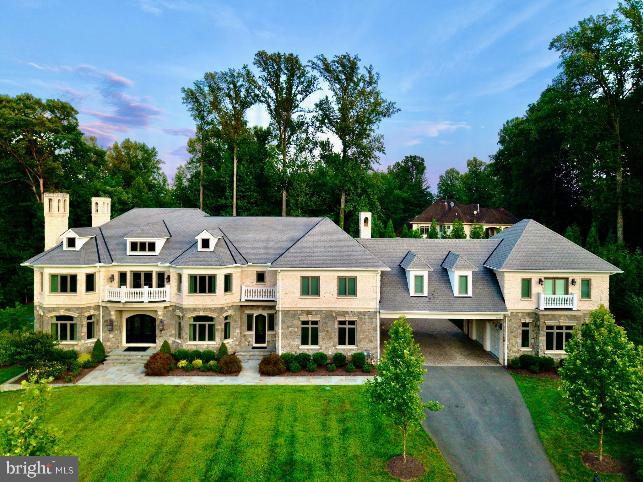 Discover the epitome of luxury and elegance at 1039 Aziza Court, a magnificent estate located in the prestigious area of Great Falls. This stunning property, set on approximately 2 acres of beautifully landscaped grounds, offers an almost 15,000 Sq Ft seamless blend of timeless design and masterful craftsmanship, perfect for those seeking a sophisticated lifestyle.GRAND INTERIORS:Upon entering this luxurious home, you are welcomed by a sweeping foyer featuring 2 grand crystal chandeliers. The soaring ceilings adorned with intricate crown molding add to the home's sophistication and grandeur. GOURMET KITCHEN HAVEN:The state-of-the-art gourmet kitchen is designed for culinary enthusiasts. It boasts a 60-inch Wolf Range with double ovens, a griddle, and a pot filler water tap. The kitchen is equipped with two hammered copper farm sinks, two Miele dishwashers, and a built-in microwave, offering ample space for multiple chefs to work simultaneously. Custom cabinets and a smart layout make culinary experiences both easy and delightful.LUXURY PRIMARY SUITE SANCTUARY:Retreat to the tranquility of the primary suite, a private haven featuring a generous seating area, a cozy two-sided fireplace, and a retreat kitchen area with refrigerator. The lavish ensuite bathroom is designed for ultimate relaxation, with heated marble floors, a two-person spa, Kohler steam shower, and separate his-and-her sink areas. Step onto the private terrace off of the master suite to enjoy stunning views of the tranquil lush gardens.OUTDOOR PARADISEExperience the ultimate outdoor paradise with four fireplaces, a pizza oven in the outdoor kitchen, and an Olympic-sized pool with a bubbling spa. The outdoor area is perfect for alfresco dining and entertaining year-round. Enjoy the basketball court, which easily converts to a pickleball court, and a beautifully landscaped garden with 31 point irrigation and lighting systems.MODERN CONVENIENCESThis smart home is equipped with "Savant," allowing you to control lighting, TV, music, indoor gas fireplaces and shades effortlessly. A Tesla charger is available, and state-of-the-art exterior infrared camera security system features provide peace of mind. The full house generator ensures uninterrupted comfort and convenience no matter the weather or circumstance.Community and NeighborhoodGreat Falls offers charm, exclusivity, and top-tier amenities logistically situated in the heart of Northern Virginia and 30 minutes from Georgetown, DC. Located within the renowned Langley High School district, known for its academic excellence, this property combines serenity with access to Northern Virginia's vibrant community and resources.