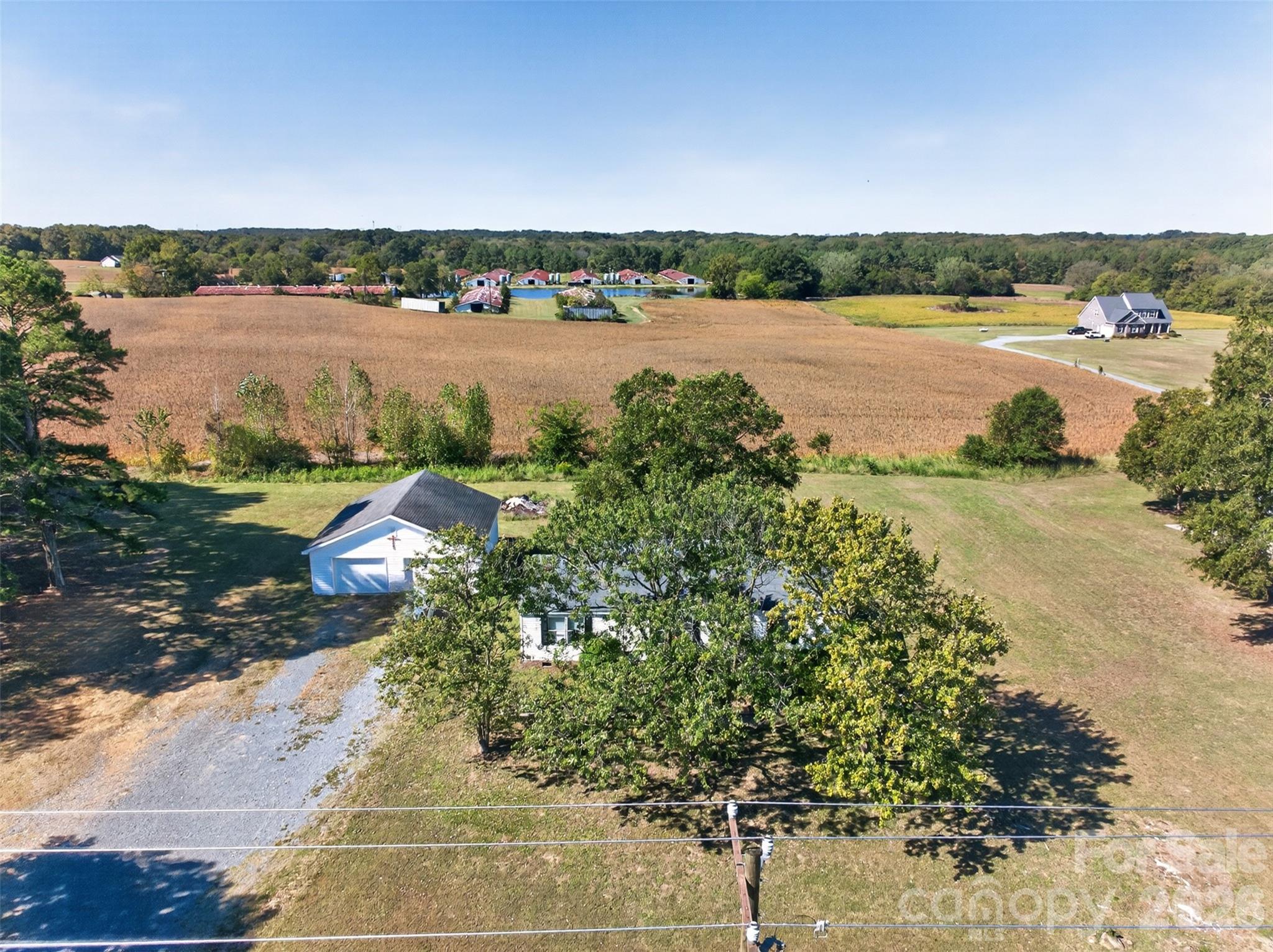 COUNTRY CHARM, PEACEFUL SURROUNDINGS & ROOM TO BREATHE!Looking for a little slice of country paradise without giving up the conveniences of town? Welcome home!Nestled on approximately 1.5 acres across two parcels, this charming, original-owner home offers the perfect blend of peaceful country living and everyday convenience! Enjoy wide-open farmland views, fresh country air, and the beauty of nature right from your own backyard.Featuring 3 bedrooms and 2 full bathrooms, this lovingly maintained home welcomes you with fresh interior paint, new bedroom carpeting, and an inviting open floor plan connecting the living room, dining area, and kitchen. French doors from the dining area lead to a covered back deck overlooking picturesque farmland—the perfect setting for morning coffee, evening relaxation, or simply enjoying the peaceful countryside.The thoughtfully designed split-bedroom floor plan offers privacy, with the primary bedroom and private bathroom separated from the two additional bedrooms and full hall bathroom. Just off the kitchen, a convenient laundry area includes cabinetry, washer and dryer connections, and direct access to the back deck.Need room for your vehicles, hobbies, or projects? The detached two-car garage offers excellent flexibility as a garage, workshop, or additional storage space!Enjoy peace of mind with several important updates, including a roof approximately 3.5 years old, a central heating and air system approximately 5 years old, and a water heater approximately 6 years old. The home is entirely electric and is served by Union County water and a private septic system.And the location? It’s country living at its finest! Surrounded by beautiful farmland, with a vineyard just down the road and a charming rural setting, this property offers a wonderful escape from the hustle and bustle. Yet downtown Monroe, restaurants, shopping, medical facilities, and everyday necessities are just a convenient drive away.Located on Plyler Mill Road with a Monroe mailing address, the property is outside Monroe city limits and subject to Union County property taxes. Schools currently identified for the area include Prospect Elementary, Parkwood Middle, and Parkwood High, with Union Academy also located nearby. Buyers should verify school assignments and enrollment availability.One owner. Two parcels. 1.5 acres. Endless possibilities!If you’ve been dreaming of a home where you can spread out, slow down, and enjoy the simple pleasures of country living, this could be the one you’ve been waiting for!Come experience the charm and tranquility for yourself!Showings start Saturday October 24th.