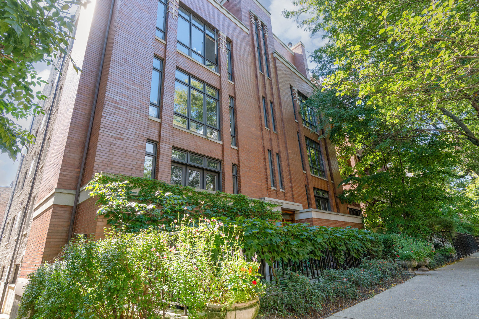 Tucked away on a quiet, tree-lined street in vibrant East Lakeview, this spacious 3 bedroom, 2.5 bath duplex-up has room for it all. With nearly 2,500 square feet, the home offers a smart, flexible floor plan with multiple living areas and ensuite bedrooms that make everyday living a breeze. The heart of the home is the oversized kitchen, complete with 42" white cabinetry, stainless steel appliances (with a new wine fridge), granite countertops, and a large island that's perfect for gathering. The kitchen opens to a casual sitting area, while a separate dining room and living room add even more options for entertaining or relaxing.  Upstairs, the large primary suite includes multiple organized closets and a freshly renovated ensuite bath (2023). Two private outdoor spaces - a balcony off the primary suite and a large back deck from the family room- bring the outdoors right to you. Other highlights include hardwood floors throughout, bright natural light, in-unit laundry, and a cozy fireplace. Many practical perks too: extra storage unit, new AC unit (2025), attached/private garage parking spot, and a heated driveway. This home truly lives like a single-family, with plenty of space to spread out.  All of this in an ideal East Lakeview location, close to the Belmont Connection shops, Nettelhorst Elementary, the lakefront, transit, restaurants, nightlife, and more!