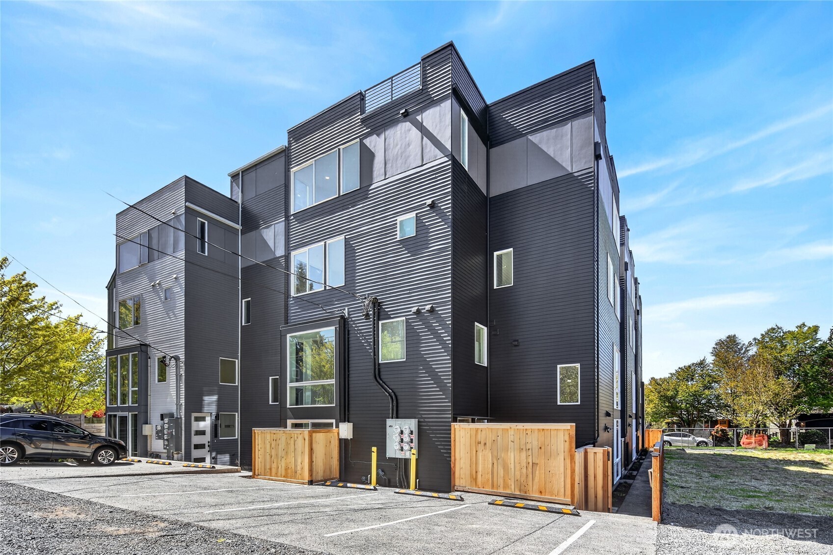 Morgan Junction - Brand-new 2026 construction, ready now. Unit D is the Middle unit home at Fauntleroy Landing. A true private retreat with Rooftop deck and a view of the Puget Sound— one shared wall, 3 bed, 2.75 bath, 1,444 sq ft across four levels. Showpiece kitchen: Matte black Samsung appliances, Deep dark Mocha cabinetry with a warm walnut accent bank, quartz counters and stacked vertical tile backsplash. Wide-plank floors. Soaring two-story window wall floods the living area with light. Two bedrooms and a full bath on the third level; the primary suite has the entire top floor to itself.  Rooftop deck plus your own rear patio. Heat pump heats AND cools. Washer and dryer included. Fee-simple unit lot: you own your land, NO HOA DUES, Two blocks to the RapidRide C Line and Morgan Junction. SELLER CREDIT — 1%, buyer's choice: closing costs, prepaids, or points to buy the rate down further. SPECIAL FINANCING: 1% first-year buydown paid by our preferred lender — stacks with the credit.