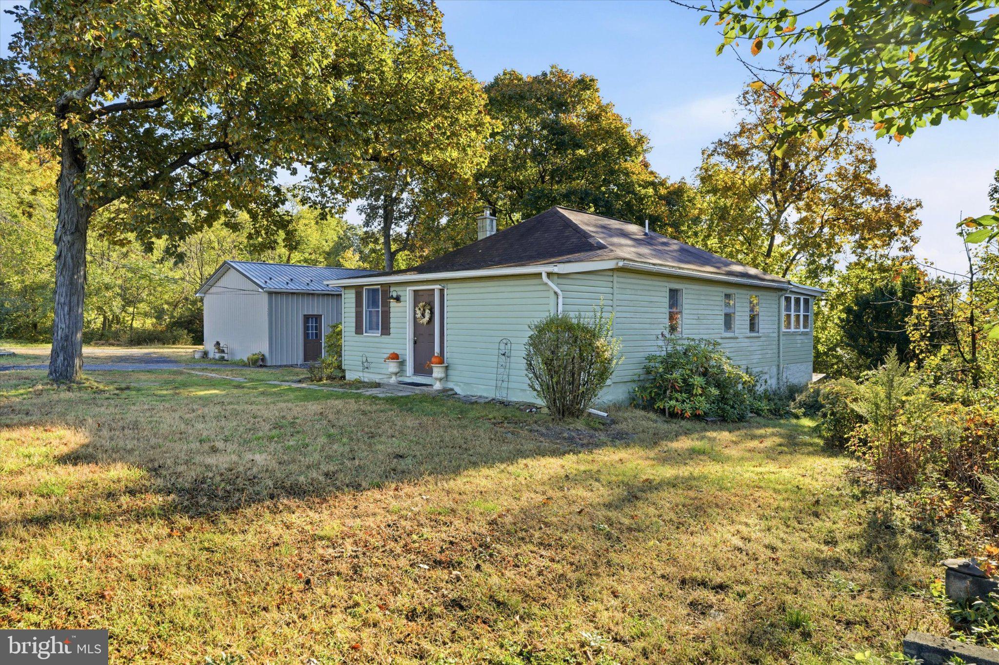 Opportunity Awaits in Perkasie! Whether you're searching for the perfect starter home, an investment opportunity, or the ideal setting to build your dream home, this charming 2-bedroom, 1-bath bungalow offers endless possibilities!Situated on a beautiful one-acre lot surrounded by custom-built homes, this property has been exceptionally well maintained and lovingly cared for over the years. Major improvements include a newer heat pump providing both heating and central air conditioning (approximately 4 years old), a new microwave, range, washer, and dryer, along with the conversion to public water and public sewer.One of the property's standout features is the impressive detached 4-car garage, featuring three bay doors and nearly 1,000 square feet of versatile workspace! Perfect for car enthusiasts, hobbyists, contractors, additional storage, or those seeking space for a potential home-based business.Enjoy the charm of the existing bungalow while exploring the possibilities this spacious property has to offer. Move right in, expand, explore building a custom home, or investigate potential business uses, subject to township zoning and approvals.A rare opportunity to own a well-cared-for home on a generous one-acre lot with exceptional garage space in desirable Perkasie!Property is being sold strictly AS IS. Seller will make no repairs or alterations.