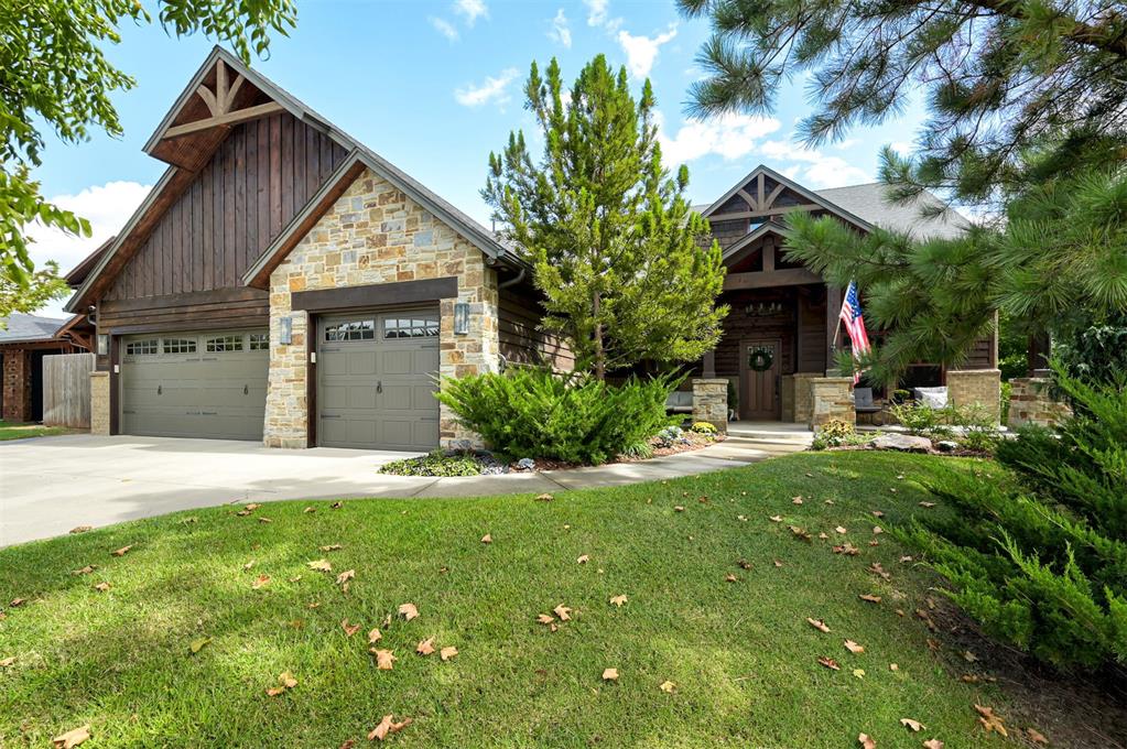 Welcome to this private retreat in the desired community of Cottage Grove, where custom craftsmanship & elevated design come together in perfect harmony. From the moment you enter this home, the richly stained wood accents & thoughtfully curated finishes set the tone for a home that is both warm & refined. The spacious living room features a beautiful stone fireplace with accent wood that carries your eyes up to the ceiling, where bold exposed beams create a striking architectural centerpiece. The kitchen has stunning custom cabinetry, a statement black hutch with purposeful storage, double islands with contrasting butcher block & a solid slab of beautiful granite that is both eye-catching & functional. The glass backsplash with pot-filler adds a great chef's touch for cooking on your Wolf Range. A private downstairs study with elegant French doors offers the perfect work-from-home retreat. The stunning primary suite is a true sanctuary, complete with a spa-like bathroom featuring a walk-in shower with river stone tile, his-and-hers vanities, and a luxurious soaker tub. & natural light filtered through classic plantation shutters. This home offers four additional secondary bedrooms with spacious closet space and plenty of room for family members or guests. Upstairs is a spacious bonus room, making it a great flex space for anyone's needs, two secondary bedrooms & a full bathroom, making it convenient for all. Throughout the home, the lighting design is as intentional as it is beautiful--from the statement pendant lights to designer ceiling fans, every detail speaks to elevated taste. This home backs up to a wooded greenbelt with captivating forest views, a private oasis. Enjoy the view from either your covered patio or the extended Trex deck built to support a swim spa/hot tub. An attached insulated shed and fire pit are an added bonus. This home is perfect for entertaining family & friends, stargazing, gardening & nature lovers, make it yours today!