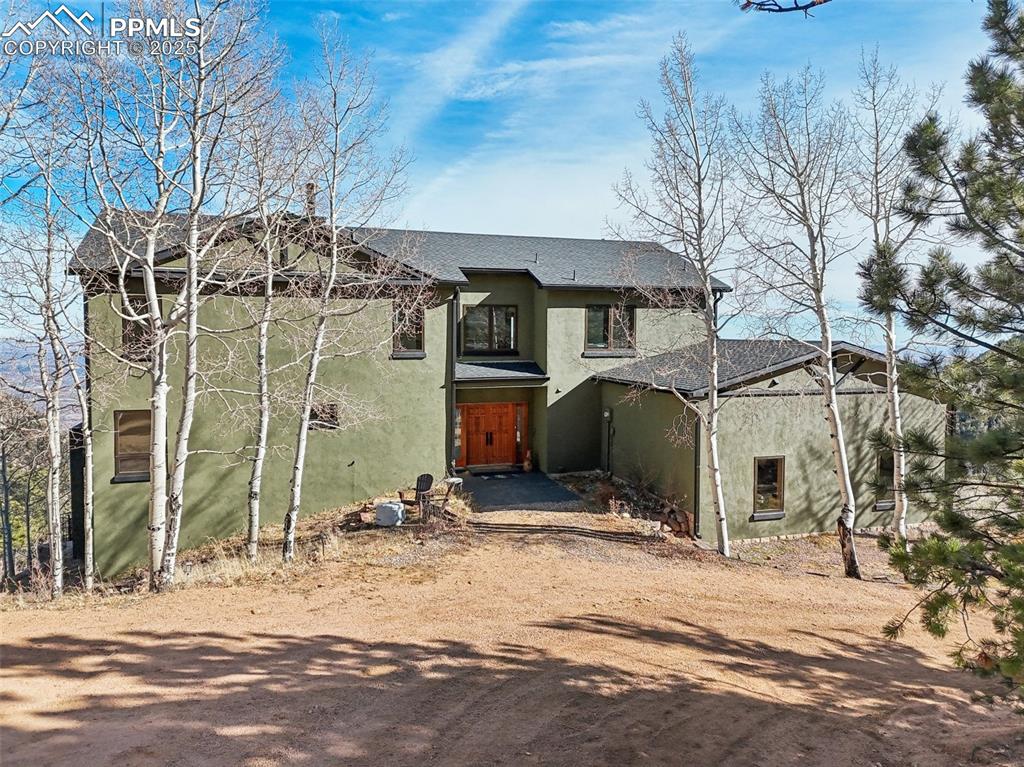 Welcome to this MUST SEE mountain retreat at the top of Crystal Park in beautiful Manitou Springs, CO!!! This home is designed for the art of living with nature! Everywhere you look you are surrounded by the great outdoors, the mountains, the pines, aspens and views! Here at 9,000 feet in the foothills of the Pikes Peak is an awesome panorama with mountain and city views that with take your breath away! The home was built working with a national award-winning architect to create this amazing custom home. It was designed specifically for perfect comfort, minimal maintenance, an allergen free environment (radiant heat), outstanding strength (insulated concrete and steel construction), and exceptional efficiency (geothermal heating). Enter through double hand-carved doors into the grand open concept living room/dining room/kitchen giving a dramatic impression with 27 foot high ceilings, majestic fireplace, and oversized windows that showcase the stunning views! In the Summer, step out onto the deck and enjoy all of nature while relaxing. In winter, cozy up to the custom fireplace while watching snow fall outside. In the main level primary bedroom you'll be in awe watching the moving clouds through the skylights or from your private balcony. In the primary bath, the whirlpool tub awaits! Relax and get a massage while taking in private mountain views. Upstairs you have 3 private bedrooms which all feature en suite bathrooms. On the lower level you have a walkout basement and you can enjoy a movie or play a game of pool in the recreation room. The walk out has covered patio with a dog run. The lower level has ample storage, 2 bedrooms and a full bathroom. Recent updates: fresh stucco, dog run, hot tub wiring, back porch and stairs, ovens, heating system, water heater, roof/gutters, high end secure dog door, all en suite baths remodeled, updated hardware throughout the home, refrigerator, grout, mirror in primary, interior paint/retexture, exterior lighting and chandelier.