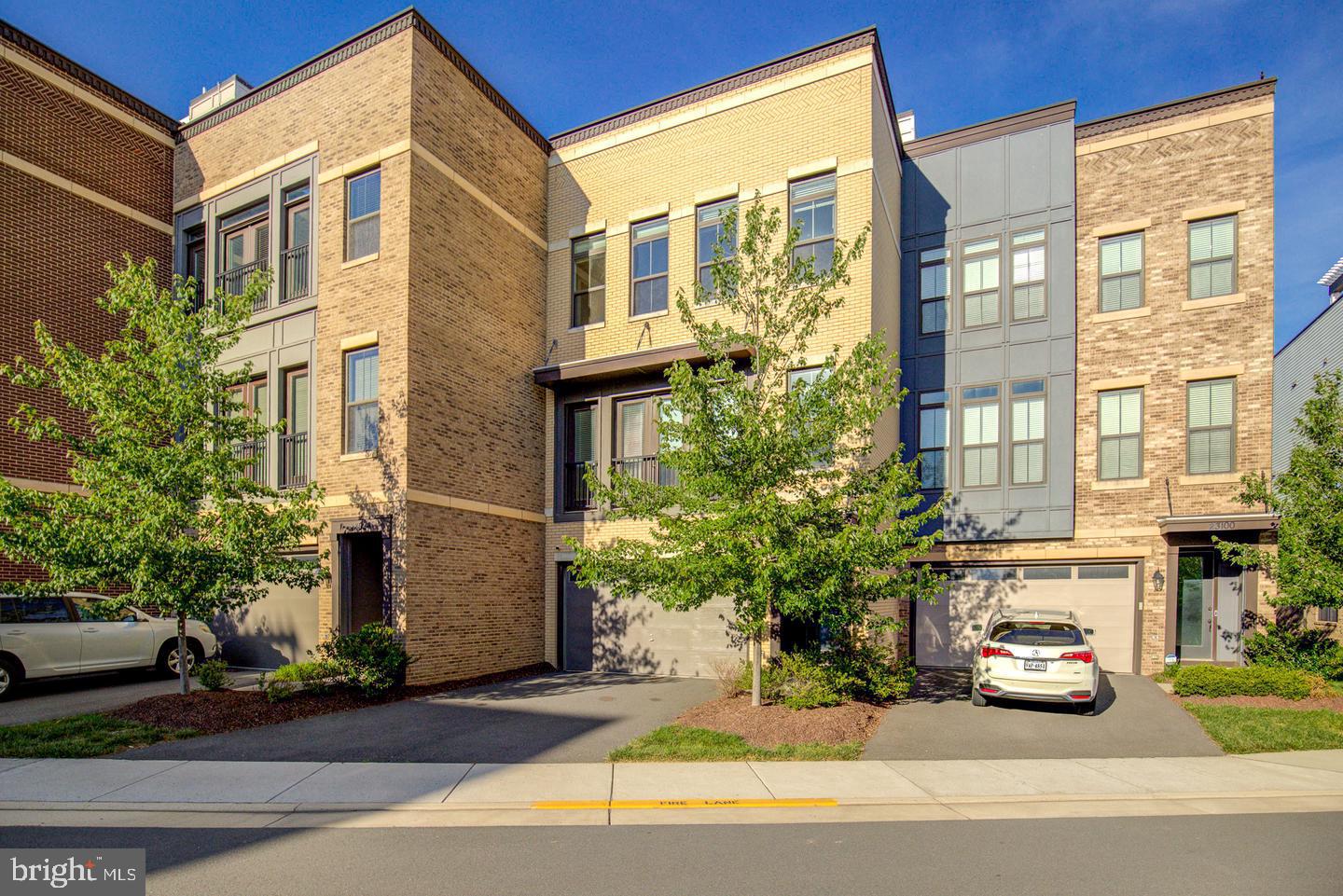 PRICE REDUCED! Nestled just steps away from the Brambeton Town Center, this exquisite former model townhome offers a luxurious lifestyle defined by its stunning water views from the roof top terrace. Built in 2020, this residence boasts 3,260 square feet of designer living space, where every detail has been curated for comfort and sophistication. The heart of the living area features a cozy fireplace, perfect for creating warm memories during cooler evenings and walks out to an expansive deck. The open layout encourages effortless entertaining with the fun of a custom built wet bar on the lower level. The master suite serves as a private retreat, featuring ample space and serene views that invite tranquility. Each bathroom is elegantly finished, ensuring a spa-like experience at home. This property is not just a home; it's a lifestyle. The community's amenities enhance your living experience, providing opportunities for relaxation and recreation right at your doorstep. Experience the perfect balance of luxury and comfort in this stunning townhouse, where every day feels like a getaway.