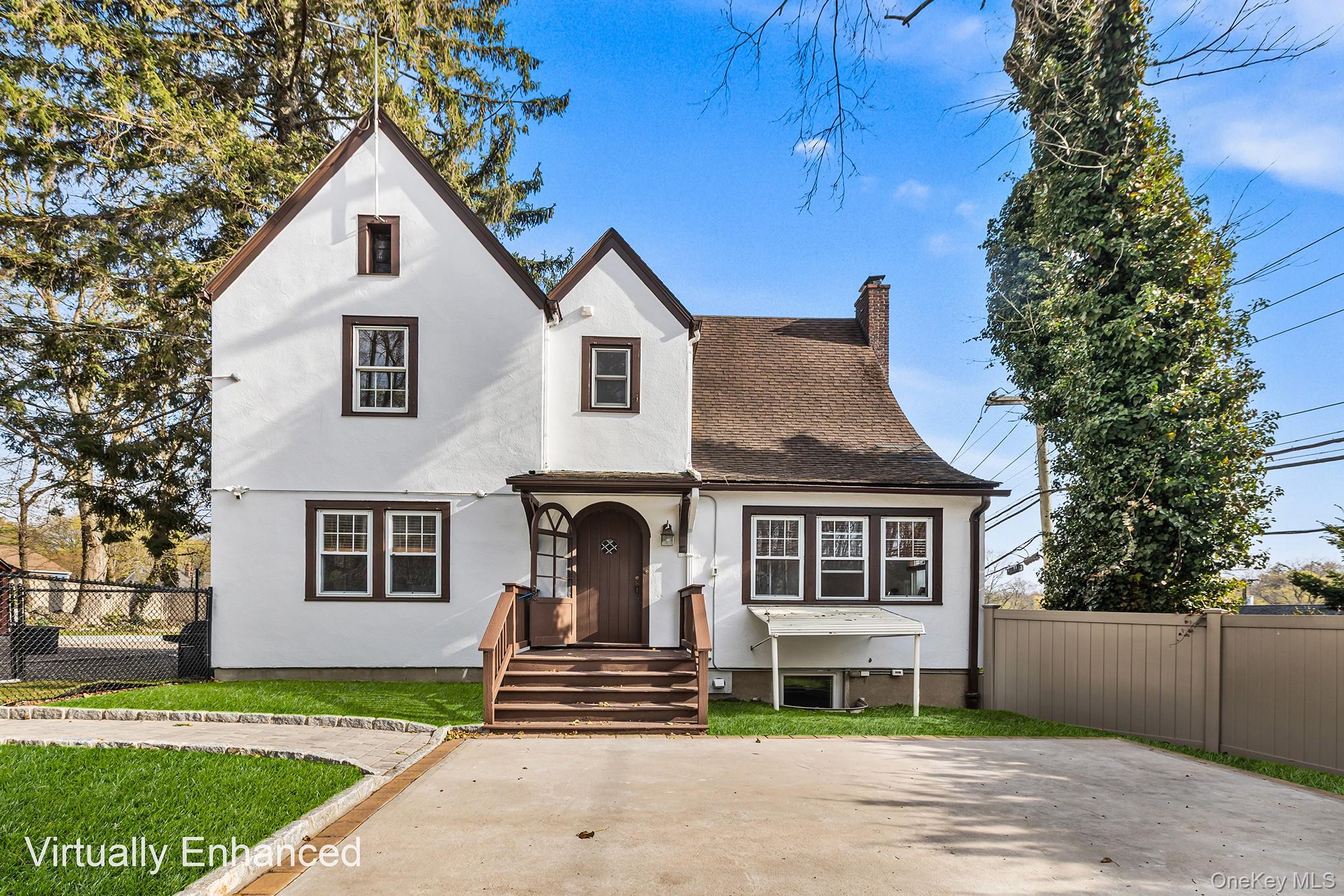 A stunning floor-to-ceiling stone fireplace anchors the spacious living room, which flows seamlessly into a bright sunroom surrounded by a wall of windows that fills the space with natural light. The large dining room connects to a beautifully designed eat-in kitchen featuring a breakfast bar and direct access to the expansive backyard. Outdoors, a patio and gazebo create an ideal setting for gatherings of any size.The upper level offers a generously sized primary bedroom with custom closets, along with two additional well-proportioned bedrooms, each with ample closet space, and a tastefully appointed full bath. A full walk-up attic provides abundant storage options and includes a cedar closet.The finished lower level adds valuable living space with a full bath, dual washer and dryer setups, access to the garage, additional storage, and a direct walkout to the yard.Ideally situated near transportation, shopping, parks, and recreational amenities, with convenient access to commuter routes, including bus and rail options for travel to New York City.