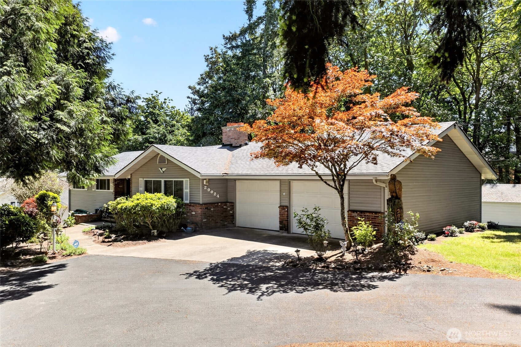 Opportunity knocks in sought-after West Hills Auburn! This spacious 3,000+ sq ft daylight rambler sits on a picturesque .67-acre lot surrounded by mature greenery and peaceful natural beauty. Full of character and potential, this rare King County property is aggressively priced and sold AS-IS, offering an incredible opportunity to build equity and bring your vision to life.  With great bones and timeless charm, this home simply needs a gentle hug to shine again. Ideal for multigenerational living, the flexible floorplan offers spacious gathering areas plus room for privacy and separation. The partially finished daylight basement provides additional potential for guests, extended living, hobbies, or work-from-home space.  Inside features 5 bedrooms, 2.75 baths, and 3 fireplaces that add warmth and character throughout. Original details like the flagstone entry add classic appeal, while large windows fill the home with natural light and showcase the serene setting.  Several major updates have already been completed, including newer piping throughout, newer roof, and newer furnace—providing a solid foundation for future improvements. Enjoy the expansive deck overlooking lush greenery and the oversized lot with endless possibilities for outdoor living, entertaining, or gardening.  Convenient commuter-friendly location with easy access to major routes, shopping, dining, and amenities. Rare opportunity for investors, flippers, or buyers ready to create their dream home.