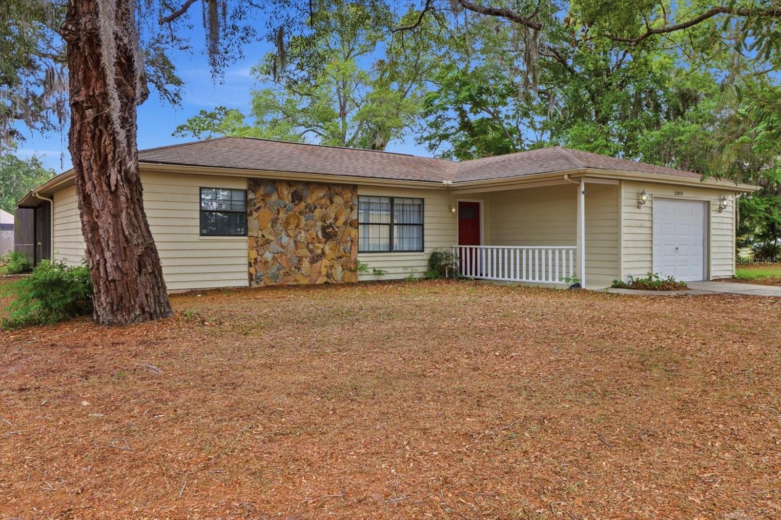 Welcome home to this charming 2-bedroom, 2-bath, heated pool home with a 1-car garage, offering 1,249 square feet of living space and situated on an oversized corner lot with mature trees providing privacy and shade. Enjoy comfortable indoor and outdoor living in a great Florida setting.The kitchen features wood cabinetry, plenty of storage, and a built-in coffee bar. The home offers a functional layout with comfortable living areas.Step outside to enjoy the covered lanai and screened 14x28 heated vinyl pool, featuring a new pool liner installed in 2024. The expansive oversized yard offers ample space for pets, gardening, and recreation, while a separate gated fenced enclosure adds extra functionality and convenience.The one-car garage offers extended space for storage, hobbies, or workspace flexibility.With its corner lot location, mature landscaping, and spacious outdoor areas, this home offers a great blend of comfort, privacy, and functionality. Just minutes from hospitals, shopping, restaurants and the Suncoast Parkway which will get you to Tampa in 45 minutes. This is a must see!
