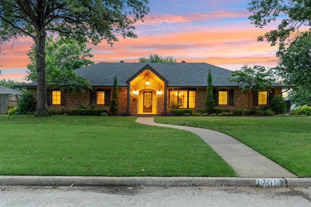 OPEN HOUSE SUNDAY 9/14 2-4 PM. Welcome home to elevated living in the coveted Waverly neighborhood. Just one block north of Nichols Hills, this stunning stone estate sits on an expansive corner lot and exudes timeless elegance with a modern edge. Striking black-framed Andersen windows and moody exterior paint tones accented by lush, curated landscaping set the tone for a home that blends classic charm and character with transitional style. Step inside to discover a thoughtfully designed and versatile floor plan, ideal for today’s dynamic lifestyles. Custom built-in lighted bookcases, beautifully remodeled kitchen, and designer-renovated bathrooms showcase impeccable craftsmanship and attention to detail in every corner while retaining the charm one would expect. A spacious flex area offers endless possibilities whether you're dreaming of a sunroom, office, game room, or play space. Additional features include a class 4 impact resistant roof (2025), side entry garage and secondary driveway, epoxy garage floors, HVAC (2021), attic insulation (2023), and in-ground storm shelter (2024). Do not miss the detached workshop equipped with electricity perfect for hobbies, storage, or future projects.  The backyard is a true highlight, offering ample space for a future pool, while currently serving as a picturesque venue for entertaining and relaxing with family and friends under the covered patio or around the circular fire pit under the stars. This gem offers the best of both worlds peaceful, upscale residential living with close proximity to parks, and the shopping and dining options along Western Avenue. If you know the neighborhood, you'll know this house. 1201 Westchester Drive is truly incomparable to other properties; it isn’t just a home, it’s a lifestyle.