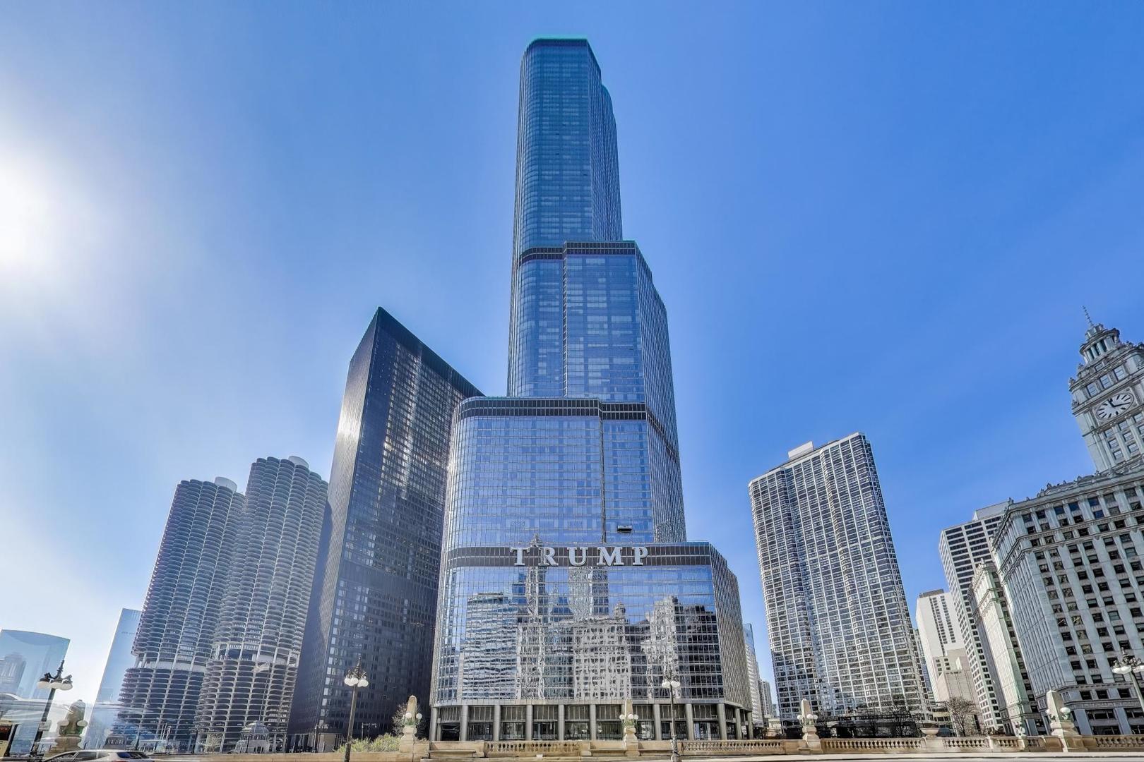The Epitome of Sophisticated High-Rise Living at Trump Hotel and Tower! Designed by world renowned architect Adrian Smith, this building is often referred to as the Burj Khalifa of the US. Welcome to this exquisite 2,100 sq. ft. 2-bedroom, 2.5-bath residence offering an unparalleled lifestyle in one of Chicago's most iconic addresses.  The "J" tier unit is extremely sough after with floor-to-ceiling windows showcasing breathtaking east-facing views of the river, lake, and skyline, setting the stage for elevated city living. Designed with elegance and functional design in mind, the open-concept layout features a dedicated dining area framed with custom wainscot panelled walls, conveniently located off of the kitchen and a spacious living area anchored by a sleek fireplace, ideal for entertaining or relaxing in style. The chef's kitchen is outfitted with top-tier appliances, including a Sub-Zero refrigerator, Miele gas cooktop, and Wolf oven and microwave, all complemented by luxurious quartz countertops and a full-height backsplash. Stylish and functional shelving system flanks the kitchen sink. Retreat to the generously sized bedrooms with custom walk-in closets. Primary suite includes 2 generous walk-in closets and spa-inspired en-suite bath. Additional highlights include in-unit washer/dryer, RH light fixtures and abundant storage in the unit. One storage unit and one full sized premium parking space included in the price. Enjoy access to world-class, 5-star amenities including 24 hour concierge service and door staff, room service, a state-of-the-art 30,000 sf. luxury fitness center, spa and 75 ft. indoor heated pool, dog walk, a residence terrace, and fine dining restaurant and terrace - all within the comfort of your own building. A rare opportunity to own a piece of true luxury in the heart of Chicago.