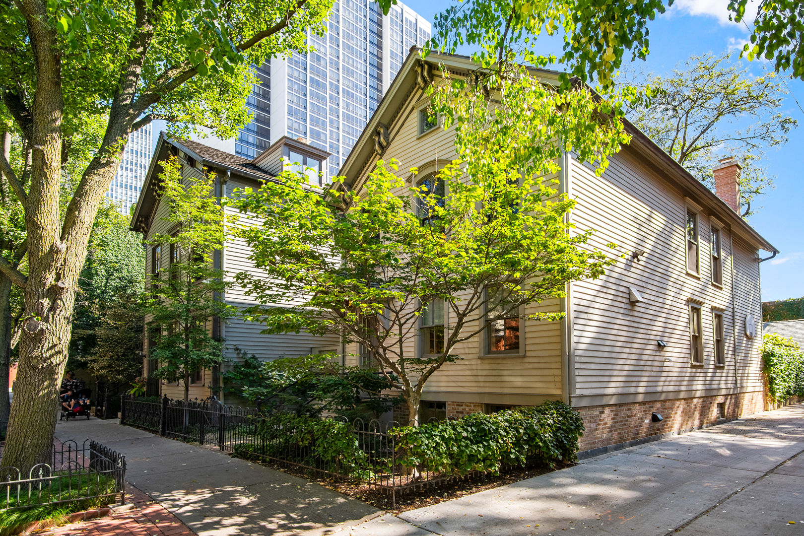 The most discreet and elegant residence in all of historic Old Town. Situated on nearly 3 lots, this architecturally significant and tech forward home offers a lifestyle unlikely to ever be replicated. The grounds consist of a light-filled single family home, reimagined historic 'fire cottage', lush gardens, and an oversized 2 1/2 car garage connected by heated walkways. The primary residence, carefully designed by the current owners and renowned Rugo Raff architects, boasts natural light in every room with detailed craftsmanship throughout. The main level offers a welcoming foyer with curved plaster walls, walnut paneled library with one of 5 wood burning fireplaces, hand crafted staircase, a mezzanine, separate living room and dining room flanked with built-ins and floor to ceiling windows, piano room, and a true commercial grade kitchen. The entire west wing of the main level was raised to accommodate the basement expansion and the Food & Wine Magazine featured kitchen, one of only a handful of residential kitchens built by SML, the company that creates Michelin-starred kitchens. The second floor features a full floor primary retreat with large, custom walk-in closets, oversized bathroom w/ large open shower, teak ceiling, and skylights, heated flooring and sep water closet, and a private sitting room w/ adjacent home office. A third floor attic is a private study and quiet home office that completes the East wing of the home. Over the glass bridge is the family wing with two large bedroom suites, each with a reading loft perfect for homework or sleep overs. The lower level encompasses a generous family game and media room, modern wine cellar, and flex Rec room/music room/additional bedroom, large laundry center & full bathroom w/ walk-in shower. Tucked away through the gardens is a separate coach house with lofted bedroom space, bathroom, and kitchen ideal for guests, a gym, and art or yoga studio with a nano-wall that opens completely to the garden. The outdoor space is a fully-private walled garden with generous gathering areas, espalier pear trees, concord grape vines, arctic kiwi, and a large roof deck above an oversized 2 1/2 car garage. No expense was spared and small details abound in the creation of this meticulously cared for private compound.