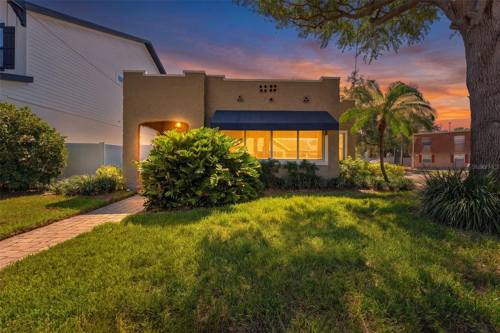 Discover one of Palma Ceia's most charming and versatile properties—a beautifully renovated Spanish Mediterranean bungalow complete with a sparkling pool and detached guest suite w a full bath! (1,400 sq ft main home plus 125 sg ft detached suite provides 1,525 sq ft of total living space), offering a rare opportunity to enjoy the South Tampa lifestyle while creating additional income or space for family.  Situated on a prominent corner lot, this timeless residence blends historic character with modern updates. The 3-bedroom, 2-bath main home welcomes you with a bright sunroom, rich architectural details, a cozy wood-burning fireplace, and an open-concept living and dining area that flows effortlessly into the updated kitchen—perfect for entertaining or everyday living.Privately tucked away, the spacious primary bedroom overlooks the pool and features a walk-in closet and beautifully updated en-suite bath. Two additional bedrooms and a second full bath provide comfortable accommodation for family and guests.Step outside to your own private backyard oasis where the newly resurfaced swimming pool creates the perfect setting for relaxing weekends, outdoor gatherings, or enjoying Florida's year-round sunshine.Adding tremendous value is the detached guest house with its own full bathroom and private entrance. Whether you're looking for an in-law suite for extended family, home office, fitness studio, or an income-producing rental, this detached studio provides incredible flexibility that few homes in Palma Ceia can offer. A separate laundry room and generous storage area make it even more functional. As an upgrade to the neighborhood, underground electrical service is currently being installed, which has temporarily affected portions of the front/side lawn.Recent improvements provide peace of mind, including:           • New Roofs being installed July 2026•   Pool resurfaced (2026) • Deck refinished   (2026)    • Detached guest suite repainted (2026)• New stainless steel refrigerator (2026)• New laundry room flooring (2026)• Tankless water heater (2020)• Plumbing supply lines replaced (2020) • Updated electrical (2008)• HVAC (2018)• Nest Smart Thermostat.   Located within the coveted Palma Ceia neighborhood and zoned for top-rated schools (Mitchell Elementary, Wilson Middle School, and Plant High School.) you'll enjoy being just minutes from Bayshore Boulevard, Hyde Park Village, SoHo, Howard Avenue's vibrant restaurants and nightlife, downtown Tampa, parks, shopping, and everything that makes South Tampa one of the area's most desirable places to call home!  Plus, Its NOT in a Flood zone, so no flood insurance required!Whether you're searching for a home with room to grow, a multi-generational living arrangement, or an exceptional investment opportunity in one of Tampa's premier neighborhoods, this unique property truly offers the best of all worlds!