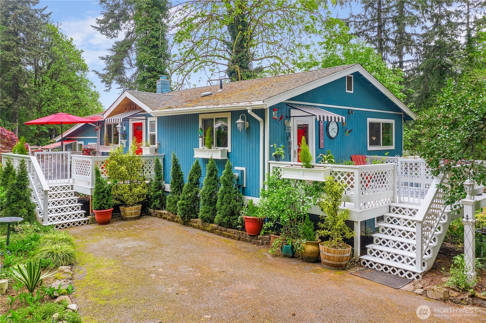 Discover your perfect home near Kitsap Lake. This secluded 3 bed, 3 bath tri-level home on a serene 1/2 acre lot offers privacy and tranquility.  A private driveway leads you to this gem, featuring a gourmet kitchen with stainless appliances. The main floor has a large bedroom with outside entry, while the lower level features two primary suites with en-suite baths. One suite includes an extra room for a nursery or office. Enjoy a fenced backyard with a storage shed & gardens, grow your own vegetables & flowers.  Custom Catio for your feline friend.   Shopping Parks & Hwy 16 are minutes away. Walking distance to Elementary School. This property blends convenience and comfort. Don't miss this opportunity to make this your own home!