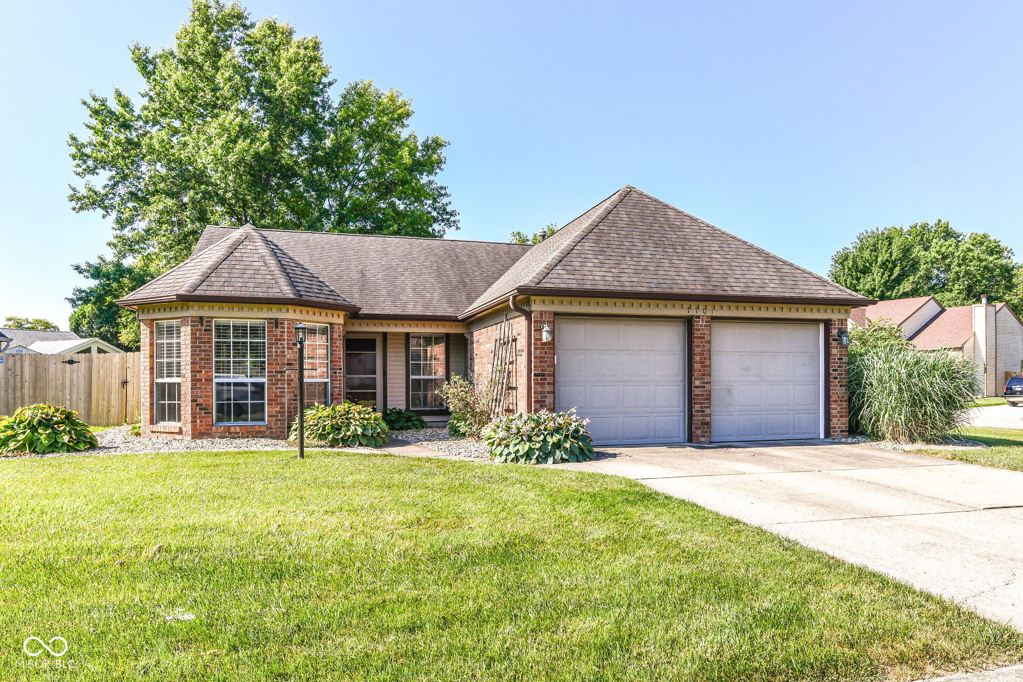 This attractive ranch-style charmer offers 1532 square feet of living space, designed for comfortable single-story living on a corner lot, right in the heart of Fishers. The home features three bedrooms, providing ample space for sleeping or working. Complementing these are two full bathrooms, and the primary offers a convenient double vanity to enhancing daily routines. Fabulous Kitchen open to both the dedicated breakfast room and dining area. Great room offers a tranquil fireplace and access to the back yard. Step outside to discover a large yard with custom privacy fence, offering ample outdoor living space. A large patio provides an ideal setting for entertaining perfect for sunshine-filled shenanigans or starlit soirees. The attached 2 car garage adds convenience plus there is a mini barn for practical storage. Within the community, residents benefit from a walkable neighborhood atmosphere with reflecting ponds and a playground. This property presents an exceptional opportunity for a lifestyle of ease and enjoyment; inquire today to experience it firsthand. Then come ready to make some memories and let your imagination run wild!