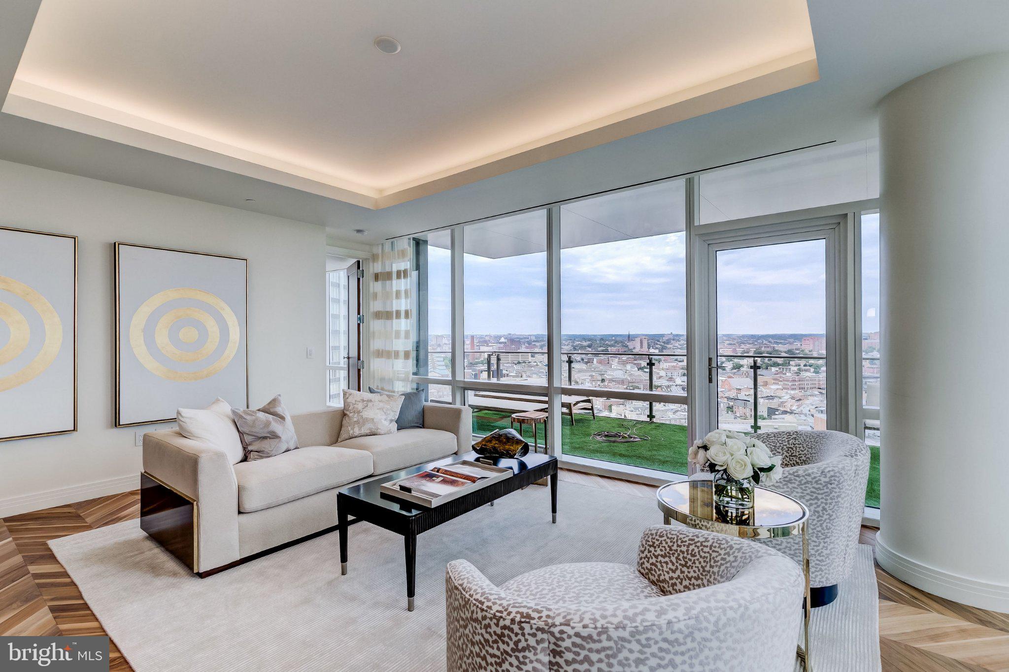 Welcome to the Four Seasons Private Residences, where luxury and location come together. In Baltimore's vibrant Harbor East, this gorgeous 1-bedroom, 1.5-bathroom unit on the 22nd floor offers spectacular views of the city skyline through floor-to-ceiling windows. The open layout brings in abundant light, complementing the rich walnut chevron floors. The gourmet kitchen features a suite of Miele appliances, elegant Eggersmann soft-close cabinetry, a huge island with quartz counters, and a beverage fridge. The balcony is a perfect spot for morning coffee, an evening unwind, or entertaining family and friends. The primary suite includes a walk-in closet and a large, luxurious bath. All windows have automatic shades, and the bedroom includes black-out shades as well. As a resident, you'll have exclusive access to the private 28th-floor amenity level, featuring an indoor saltwater infinity pool, sauna, fitness center, and outdoor deck with a grilling station. The level also includes an entertainment lounge with a billiards table, kitchen and dining areas, conference space, and a dog-walking area. The outdoor decks offer incredible views of the city and water.  Residents also enjoy full access to hotel amenities, including in-house dining, housekeeping services, pet care services, the hotel pool and fitness center, valet services, exclusive access to hotel events, and much more. A private, secure lobby ensures the safety and comfort of all.This unit comes with one dedicated parking space and one storage unit.The Four Seasons features 4 on-site restaurants, with many more exceptional dining options a short walk away in Harbor East and Fells Point. Shopping, parks, harbor activities, museums, and miles of scenic waterfront walkways are all close enough to enjoy every day, and the Orioles' and Ravens' stadiums are nearby as well.Experience relaxed luxury at the Four Seasons. It's more than a residence, it's a lifestyle.