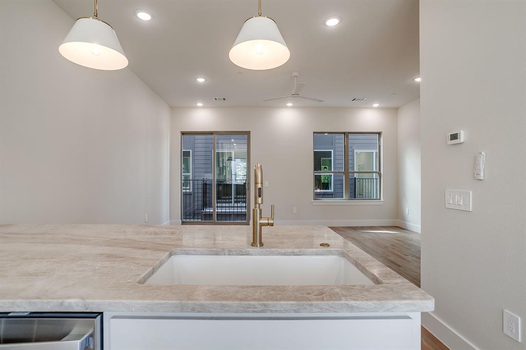 ** OFFERING 1 MONTH FREE WITH MOVE IN PRIOR TO 5-1-25! ** Experience the pinnacle of modern design & urban sophistication at Linwood Quarter, a boutique townhome community perfectly situated in one of FW’s most walkable & vibrant neighborhoods. Thoughtfully designed and built, each residence at Linwood Quarter delivers a rare balance of style, functionality & location - without compromise. Linwood Quarter offers three stunning design packages - The Terra, The Noir & The Lumen - each inspired by a distinct aesthetic and lifestyle. This unit features The Noir, emphasizing Moody Organic design: rich wood tones, dramatic stone surfaces, & dark, evocative accents that create a bold yet welcoming atmosphere. Every inch of this home is crafted with intention, blending luxury and practicality for an effortlessly elevated living experience. Inside, the curated interiors reveal custom cabinetry, natural stone countertops in exquisite quartzite and leathered granite, and real hardwood floors. High-end Delta plumbing fixtures & stainless steel GE appliances - including GAS ranges -offer both form & function, while the Energy Star efficiency rating and spray foam insulation ensure year-round comfort and performance. Expansive 10-foot ceilings on the main level! The primary suite offers the walk in shower of your dreams, dual vanity and walk-in closet. LOTS of storage! Bonus built in desk workspace. The oversized garage easily accommodates SUVs, bikes & extra gear. Upstairs, the private rooftop terrace invites you to unwind or entertain against the backdrop of panoramic downtown Fort Worth views.Linwood Quarter is steps from Linwood Park, walking distance to the new $1.7B Westside Village & UNT Health Science Center, & just three miles from TCU & TAMU Law School. Here, refined design meets unmatched location - creating an urban sanctuary where luxury feels effortless & every detail reflects your sense of style.