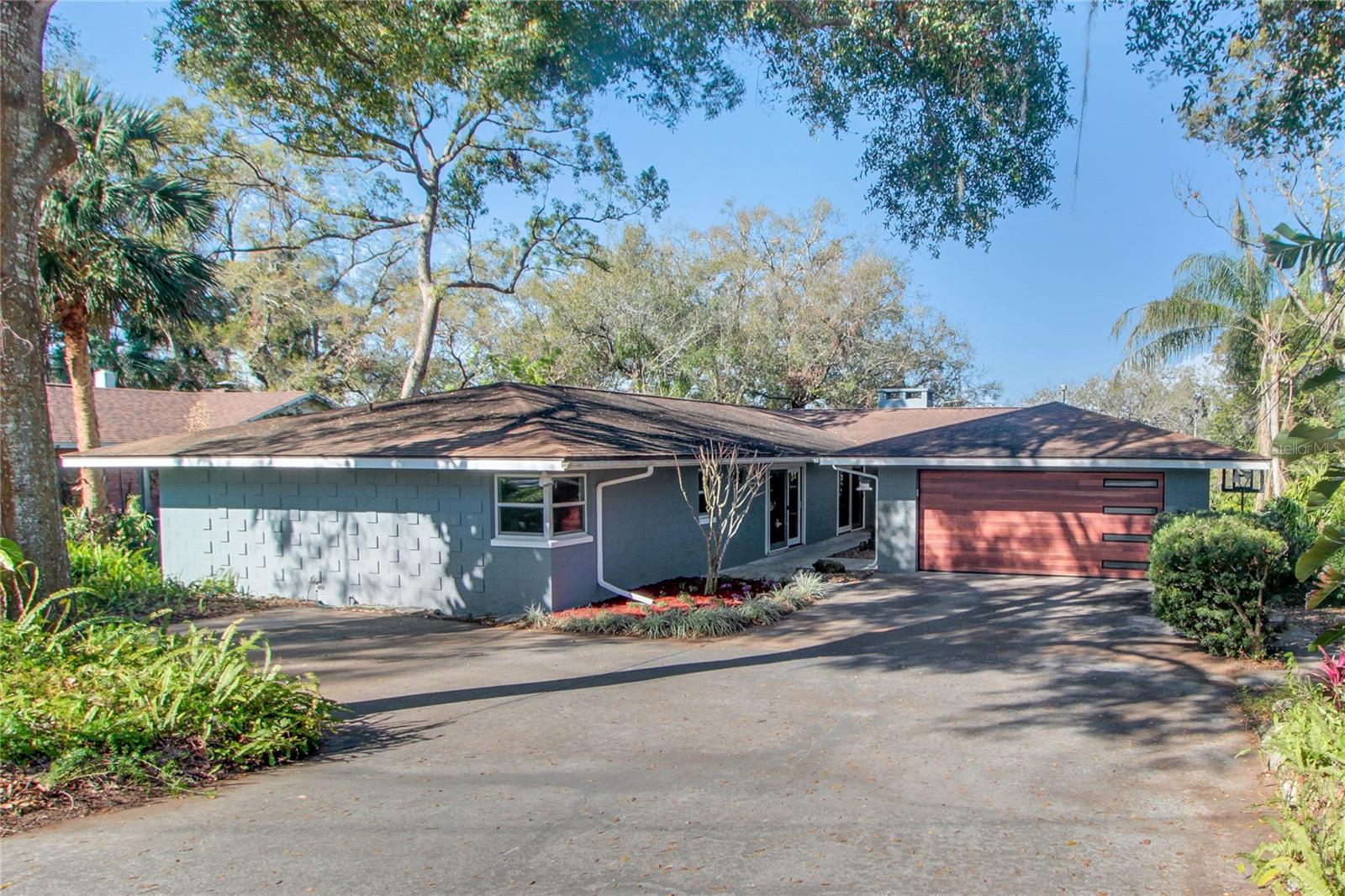 *PRICED BELOW RECENT APPRAISAL! YOUR INSTANT EQUITY OPPORTUNITY JUST GOT BETTER! Step into timeless elegance with this stunning 1965 mid-century modern home with its BRAND NEW Septic System. Nestled in the quiet, friendly Pinecrest neighborhood with breathtaking views of Lake Gertrude, this SPACIOUS block home offers 2,734 Sq Ft of beautifully crafted living space. The 4 Bedroom, 2.5 Bathroom home combines classic charm with modern conveniences. Classic wood floors and elegant crown molding flow throughout, adding warmth and sophistication. The comfortable Living Room, anchored by a cozy gas log fireplace, invites relaxation and effortless entertaining. At the heart of the home, a recently remodeled gourmet Kitchen awaits, featuring soft-close cabinetry, gleaming granite countertops, stainless steel appliances, a dual oven, and a large island—perfect for culinary creativity. Step out onto the Rear Balcony to take in the serene, sloped backyard and the tranquil vision of Lake Gertrude. Enjoy peaceful mornings and stunning sunsets in this picturesque setting. Nearby walking paths provide the perfect escape into nature, while downtown Mount Dora’s charming shops, restaurants and activities are just minutes away. An unfinished basement provides plenty of storage space or would make an ideal workshop. This well-maintained home has been freshly painted and features brand-new front and garage doors, making it truly move-in ready. The roof was replaced in 2010, and the AC, installed in 2013, has been regularly serviced, seamlessly blending historic charm with modern comfort. NEW Septic tank & drain field- 2025. More than just a home, it’s a retreat, a lifestyle, and a rare opportunity. Don’t let it slip away!