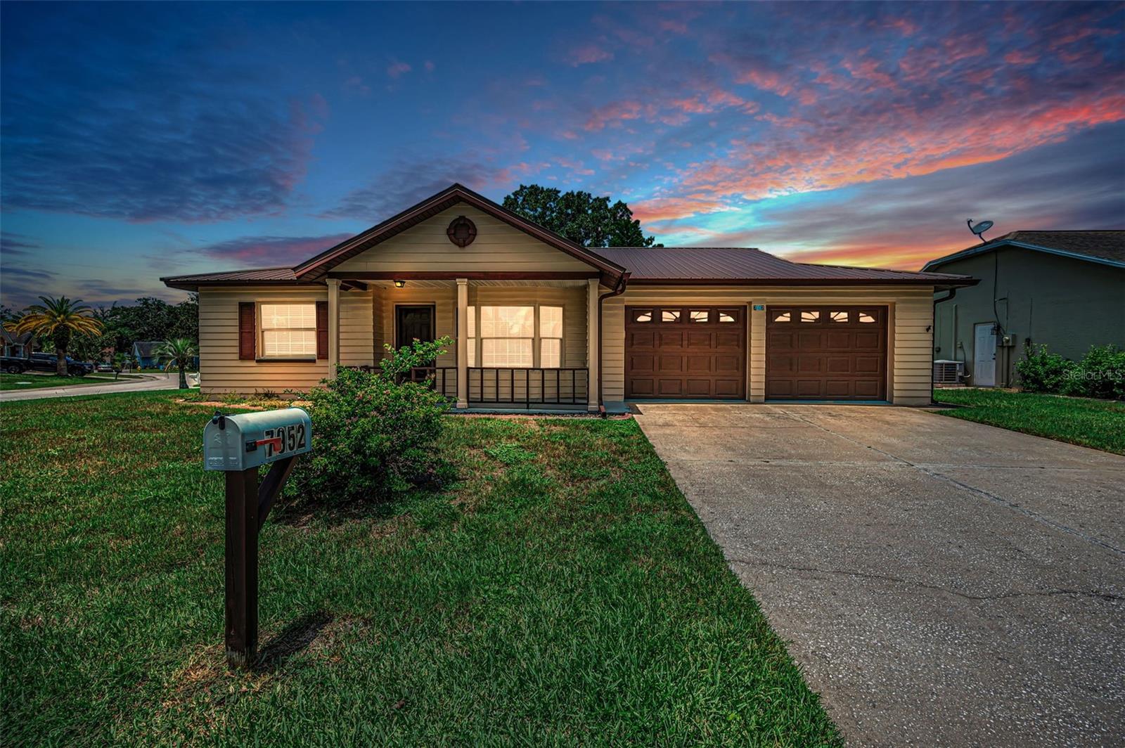 Virtually Staged. Welcome home to this warm and inviting 2 bedroom, 2 bathroom home filled with natural light and comfortable living spaces throughout. Relax on the welcoming front porch before stepping inside to discover a bright living room highlighted by a beautiful bay front window and an open floor plan designed for easy everyday living. The spacious layout flows seamlessly from the living and dining areas into the kitchen, featuring black appliances, a breakfast bar, and convenient closet pantry. Just beyond, the cozy family room at the back of the home offers the perfect place to gather, with French doors leading into the sunroom - an ideal spot to enjoy your morning coffee, unwind with a book, or take in views of the large backyard. The split bedroom floor plan offers privacy and comfort for both owners and guests. The primary suite features a walk-in closet and ensuite bath with dual sinks, tub/shower combination, and extra storage closet. The secondary bedroom is generously sized and located near the guest bath. Freshly painted with brand-new carpet, this move-in ready home also includes a 2-car attached garage and plenty of space to enjoy both inside and out. Conveniently located near shopping, restaurants, and medical facilities, this home offers the perfect blend of comfort, convenience, and charm. Schedule your private showing today and see why this feels like home the moment you walk in.