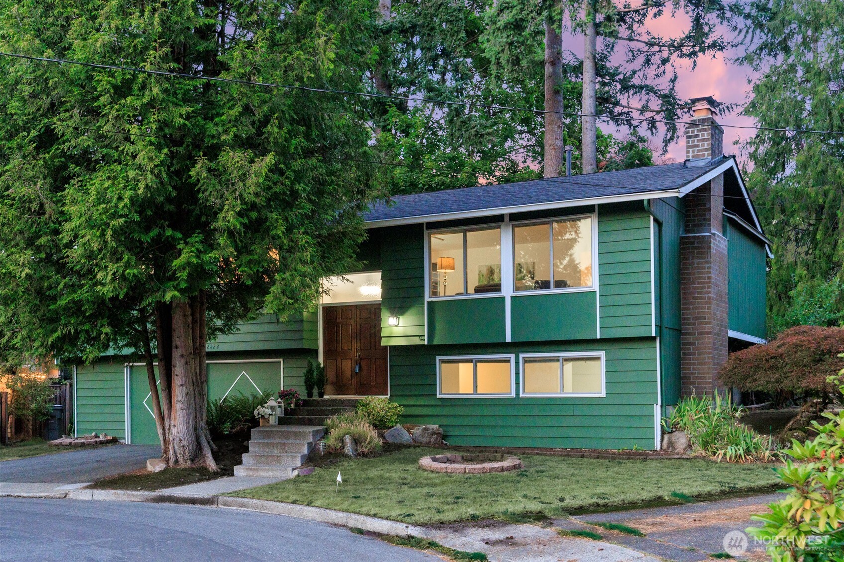 Welcome to this charming mid-century modern gem in sought-after Rose Hill, Kirkland - on the market for the first time ever! Newly refinished hardwood floors & quartz countertops create a crisp, move-in ready feel. New vanities & stainless steel appliances. Enjoy spacious living area, including a bright living & dining room upstairs & a generous recreation room below, offering comfort & flexibility. Three bedrooms on the main level plus a fourth downstairs - ideal as a media/game room or home office. The serene, level private yard is perfect for relaxing or entertaining. Lovingly maintained & cherished for decades, this home sits on a quiet cul-de-sac & is ready for its next chapter. Top rated Lake Washington Schools. Welcome Home!