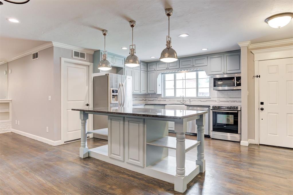 Must see! This beautifully renovated and expanded home in the Wileman subdivision blends timeless charm with modern updates and thoughtful design. With more than 700+ square feet of additional living space, the home now offers multiple living areas with a split-floor plan featuring three spacious bedrooms, and two full bathrooms. The primary suite is a true retreat, featuring a walk-in closet, jetted tub, and shower w/rain head and Bluetooth speakers. A cozy reading nook or office space provides direct access to the back deck, creating the perfect spot to relax or work from home. Inside, refinished hardwood floors and great natural lighting highlight the open-concept and provide great lighting throughout the multiple living areas! The kitchen features Bosch and stainless steel appliances, a large center island, granite countertops, and plenty of storage. Flowing seamlessly into the dining and family rooms with vaulted ceilings, this space opens to the covered deck and private backyard. Additional updates include a new roof (2023), tankless water heater, and two HVAC systems (2019 & 2025), ensuring both comfort and efficiency, recessed lighting in the dining, living areas, and primary bedroom all on dimmer switches. Conveniently located, this home offers quick access to Penn Square Mall, The Oak, Classen Curve, Trader Joe’s, and all the shopping, dining, and entertainment the area is known for.
