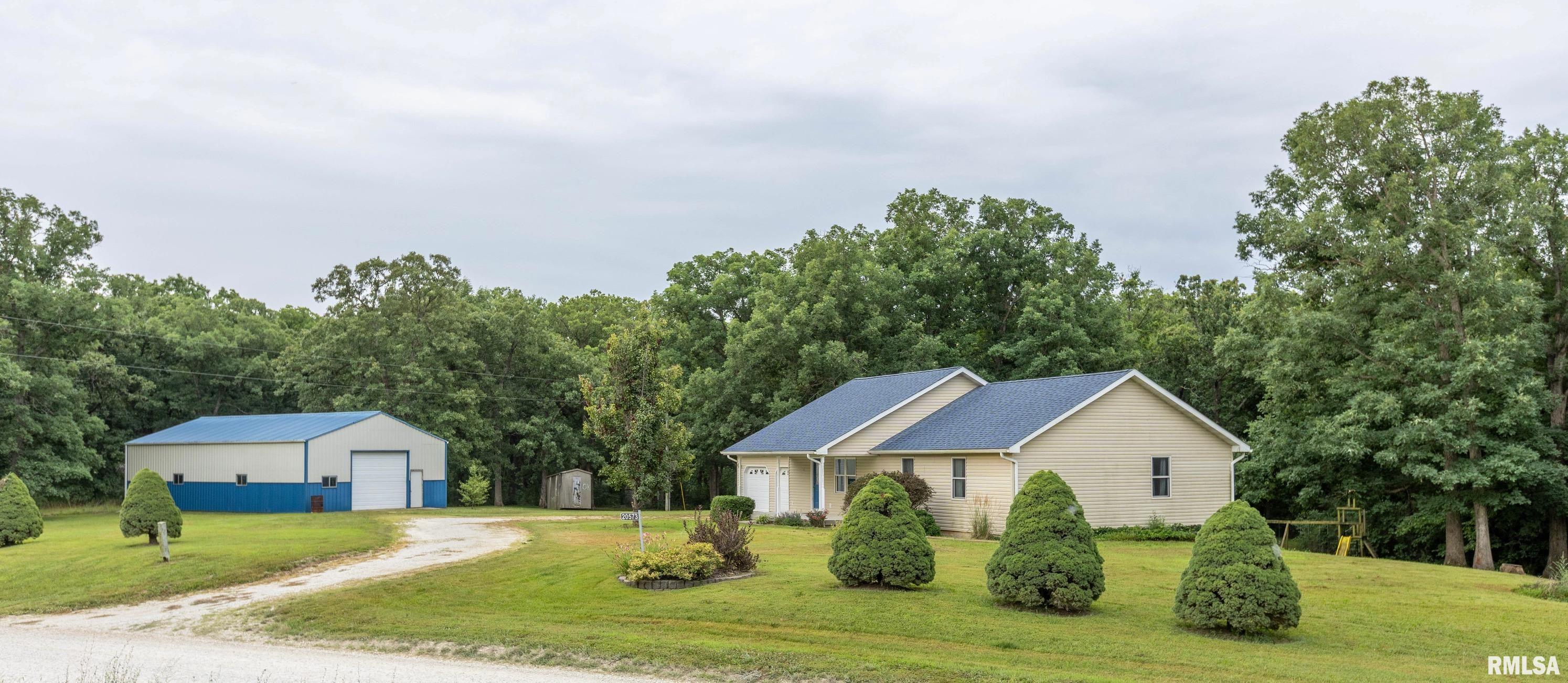 Discover the perfect combination of privacy, space, and convenience with this one-owner ranch home, built in 2007 and situated on approximately 6 wooded acres at the edge of town.   Designed for comfortable main-level living, this home offers an attached 2-car garage, main-floor laundry conveniently located off the full bathroom, and a spacious primary suite featuring a private full bath with a walk-in shower. The open and functional floor plan provides a welcoming atmosphere for everyday living and entertaining. Enjoy beautiful sunsets or sunrises from your back deck.  The full walkout basement offers endless possibilities for future expansion and is already equipped with a rough-in for an additional bathroom, allowing you to customize the space to fit your needs. Outside, you'll appreciate the impressive 30' x 52' metal outbuilding with two overhead doors, providing exceptional space for vehicles, equipment, hobbies, or workshop use. A new roof installed on the home in 2024 adds additional peace of mind as well as a geothermal system for lower utilities.  If you've been searching for acreage, a quality-built home, and the convenience of living on the edge of town, this property is one you won't want to miss!