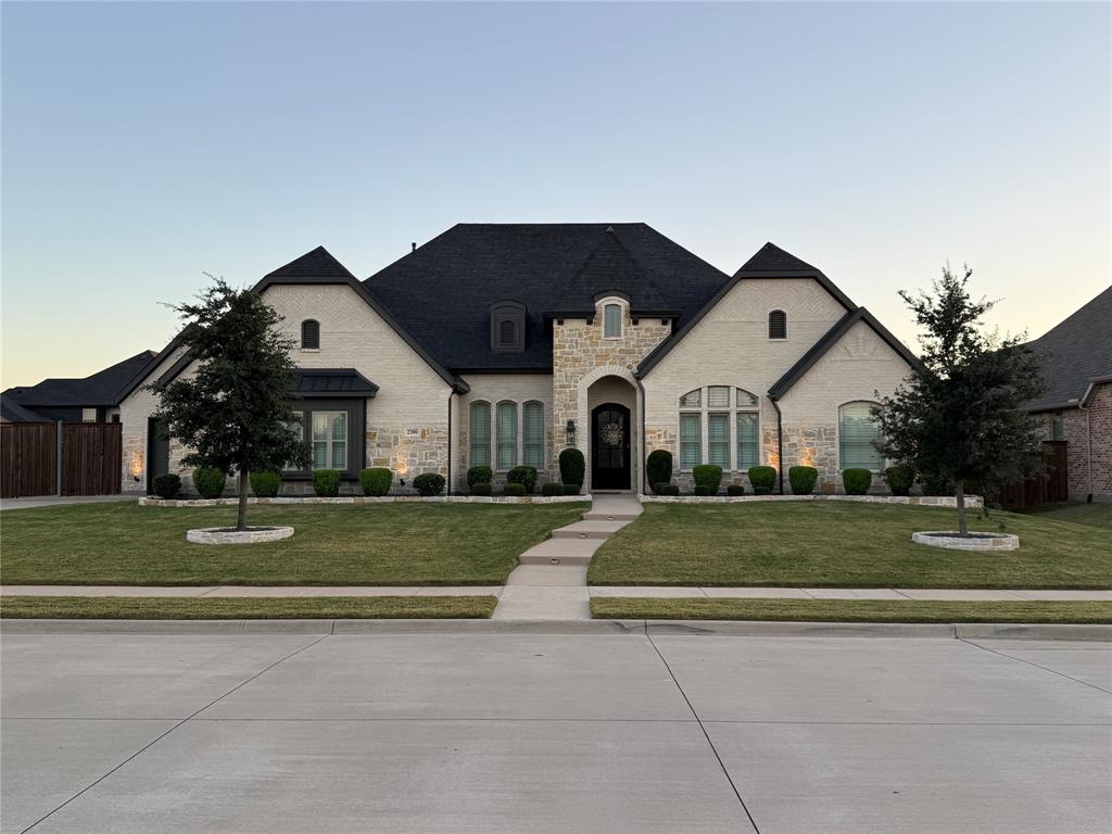 Ideally situated in the sought-after Falls of Prosper, this exquisite one-story 4-bed, 3-bath, custom-built home showcases an exceptional fusion of contemporary sophistication and enduring comfort - within Prosper ISD and zoned for Prosper High School. Set on an expansive lot of over one-third of an acre, this property offers limitless potential, elegant outdoor entertainment and shimmering pool offering peaceful relaxation. Open-concept layout with abundant natural light and engineered wood flooring throughout. Gourmet kitchen with quartz counters, stainless appliances and large island. Primary suite includes dual vanities, soaking tub, separate shower and walk-in closet. Two secondary bedrooms plus a 4th bedroom that can also serve as a study, flex or activity room. Spacious backyard features a sparkling pool and fully glass-enclosed patio, enhanced with a remote-controlled adjustable screen ideal for everyday lounging and hosting. In-ceiling speakers are installed throughout the living area, kitchen, and enclosed patio, providing seamless whole-home sound and an elevated entertainment experience.  Additional highlights include epoxy-coated flooring in both garages for low-maintenance durability and a clean, polished finish, along with an electric car charger for added convenience. This home is equipped with a whole-house generator and a high-end smart camera surveillance system, offering peace of mind and uninterrupted comfort year-round. Close to shopping, dining and main travel routes. Move-in ready and a must-see!