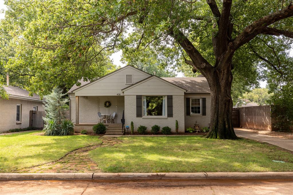 A classic Oklahoma City bungalow, beautifully refreshed. Set beneath mature trees in the Zachary Taylor neighborhood, this home blends historic charm with modern comfort and easy everyday livability. Located just minutes from Western Avenue, Classen Curve and the heart of Oklahoma City, this home offers the best of established neighborhood living. Its painted brick exterior, deep front porch and winding stone path create a warm and welcoming first impression. Inside, natural light pours through large windows accenting the warm wood floors and fresh tailored interiors. The living room feels calm and inviting and opens naturally to a dining space that brings depth and character with rich wall color and a striking brass fixture. The kitchen blends simplicity and substance with butcher-block countertops, stainless appliances, a farmhouse sink and a full wall of added pantry cabinetry for storage. The renovated bath feels like a boutique retreat finished with marble-look counters, brass fixtures and deep green cabinetry that adds both color and sophistication. Both bedrooms are comfortably sized and bright with generous closet space and new recessed lighting. Recent updates make this home as functional as it is beautiful. The sewer line was replaced in 2022, the bathroom remodeled the same year and the patio cover and carport were added in 2023 to expand outdoor living. The tankless hot water system, gas heat and automatic sprinkler system keep daily living easy and efficient. Out back, a covered patio opens to a large fenced yard shaded by mature trees—an ideal place for morning coffee, evening grilling or sitting around the firepit with friends. There’s even a storm shelter tucked in the garage floor for peace of mind. Stylish, move-in ready and perfectly situated in one of Oklahoma City’s favorite established neighborhoods, this Zachary Taylor bungalow is a polished blend of comfort, design and livability. Make it yours.