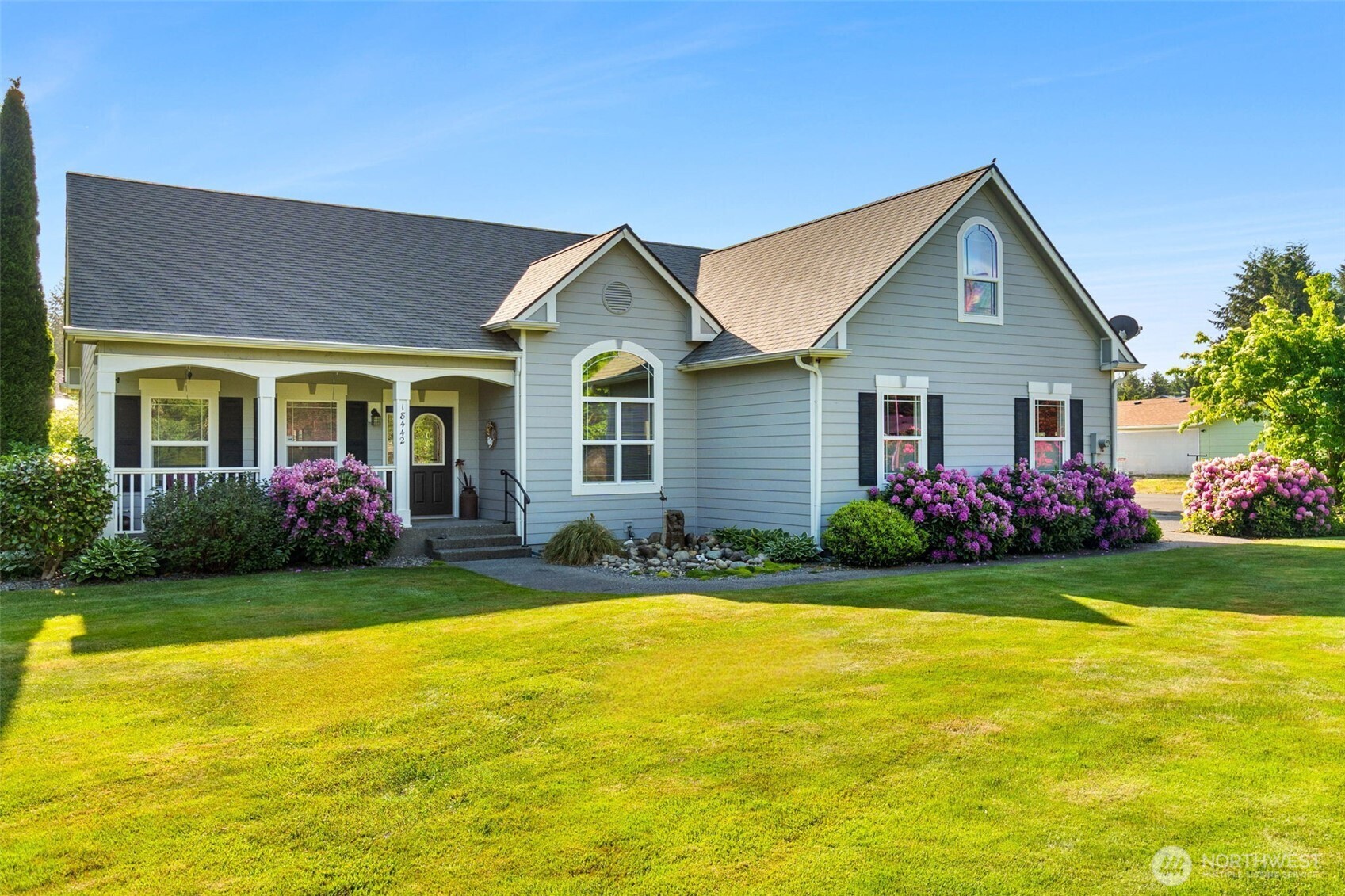 Once in a while, a property comes along that simply makes you exhale. Peaceful. Private. Beautifully cared for. Just beyond the gated entry, this exceptional Rochester retreat offers the perfect balance of security, serenity & effortless country living. This beautifully landscaped level acre is framed by vibrant rhodies, dogwoods & hydrangeas. A welcoming covered front porch overlooks a bubbling water feature & picturesque lawn—the perfect place to savor a quiet morning or unwind at day's end.    Designed for easy main-floor living, the open floorplan is filled w/natural light. Fresh paint, newer LVP flooring, vaulted ceilings & thoughtful updates create a bright, inviting home. Updated kitchen features granite counters, custom cabinetry, stainless appl, 2 pantries & a cheerful breakfast nook. Cozy gas FP, covered outdoor living & dreamy primary ste w/sitting area, walk-in closet, luxurious 5-pc bath & private patio access make everyday living a joy. Two add’l BRs each w/private vanity, walk-in closet & shared full bath. Upstairs bonus rm adds flexible living.  Apple trees, blueberries, sprinkler system, security, 35'x39' shop with loft, kitchenette, storage, workbench & 12'x12' doors, covered RV carport, 11.5'x13' garden shed, solar panels for low energy costs, newer roof, heat pump, private well & quick I-5 access complete this remarkable property! A place where neighbors wave, mornings begin w/birdsong & every day ends w/the quiet reminder there's truly no place like HOME.