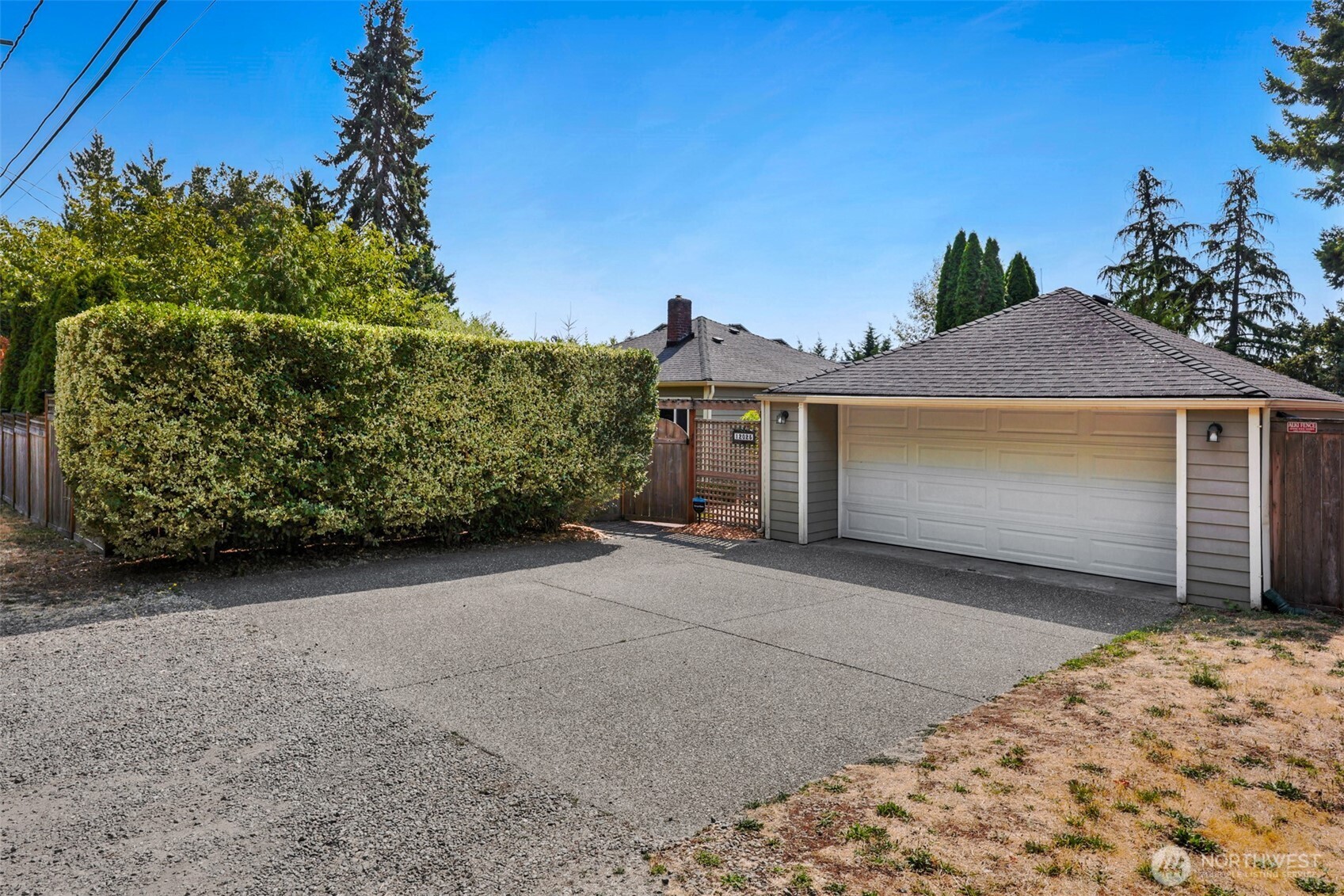 Enjoy classic charm with modern sophistication in this beautiful 1940s three-bedroom, two-full-bath home. Set on an exceptionally private 17,000+ sq. ft. lot, this inviting property boasts an open floor plan, an oversized primary bedroom, and numerous thoughtful upgrades throughout.    The main level features two bedrooms, a full bath, spacious living and dining areas, and an open kitchen designed for comfortable everyday living and entertaining. The fully finished daylight basement offers impressive ceiling height and a versatile layout, including a third bedroom with egress, full bath, family room, office, and dedicated workout space. With a full walk-out, the lower level seamlessly extends the living space to the outdoors.    Additional highlights include whole-home A/C, an upgraded electrical panel, paid-for solar panels, and a separate oversized two-car garage equipped with EV charging.    Outside, enjoy your own private retreat with mature landscaping, a large composite deck, patio, and multiple areas perfect for outdoor entertaining or relaxing.    Ideally located for an easy commute with convenient access to downtown with lots of dining & shopping opportunities.  This unique home combines timeless character, modern upgrades, privacy, and exceptional versatility.