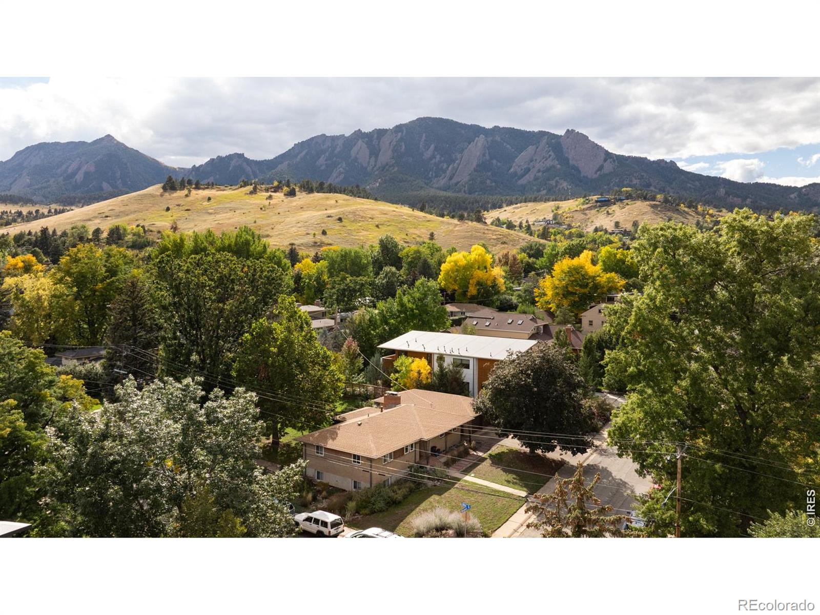 A once-in-a-lifetime opportunity in coveted Chautauqua, this rare .28-acre flat corner lot captures breathtaking, unobstructed views of the iconic Flatirons. Whether you envision designing and building your custom dream home or thoughtfully enhancing the existing five-bedroom, three-bathroom residence, the possibilities here are endless. Live comfortably on-site while you finalize plans, or reimagine the current home to suit your vision-all in one of Boulder's most sought-after neighborhoods. Inside the existing 2,792-square-foot midcentury home, the seamless indoor-outdoor layout flows from the gracious foyer to a fireplace living room, dining area and spacious kitchen. Outside, the covered patio is perfect for relaxing alongside an outdoor fireplace and a large, flat yard featuring towering mature trees, green lawns and plenty of room for a pool and spa. On the main level, the primary suite includes a private bath and an extra-wide closet. Two more bedrooms on this level share a large windowed guest bathroom. Head to the lower level to find a family room with a fireplace and bar, a private entrance, plus two more bedrooms and a third 3/4 bathroom. Generous storage and a huge laundry room complete the expansive layout, while the oversized, detached two-car garage provides generous off-street parking and room to add an ADU. This home's outstanding Chautauqua location provides front-row access to thousands of acres of open space and trails. Just minutes from your door, Chautauqua Park offers the wonderful Chautauqua Dining Hall, a quaint coffee shop and cultural events, including speakers, concerts, art exhibitions and more. Easy access to top-rated schools, Base-Mar Shopping Center and the CU campus complete this magnificent property.