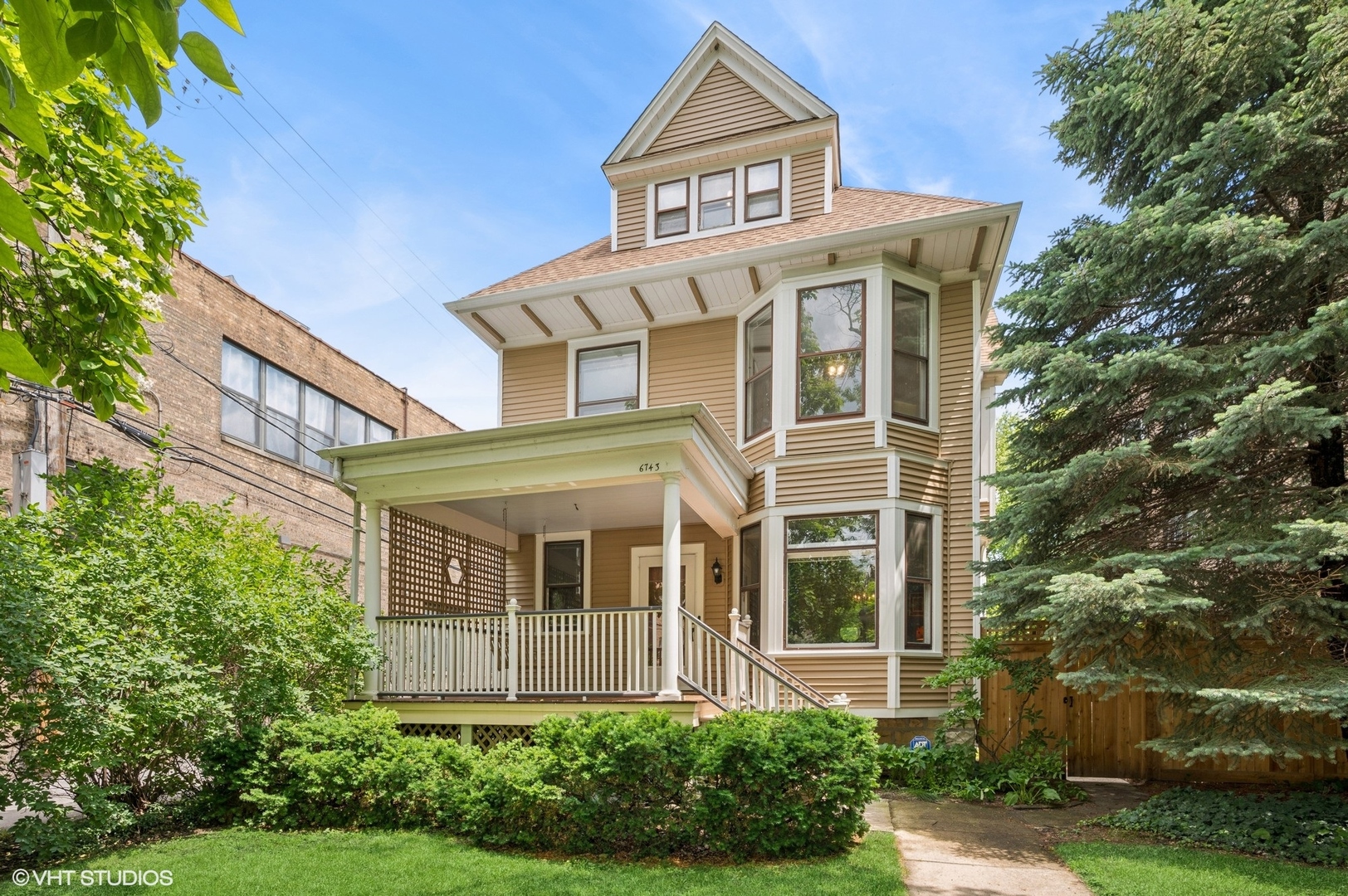 Gorgeous 5BR/2.5BA Victorian home on an oversized 50x122 lot in the heart of Rogers Park's Loyola University neighborhood. Just blocks from the El, lakefront, and dining. This 1897 gem offers a welcoming front porch with a swing, a gracious foyer, soaring ceilings, and abundant natural light. Rich in character with original woodwork, a grand oak staircase, hardwood floors, and solid wood doors, the home has been thoughtfully updated with modern infrastructure and appliances. The remodeled kitchen and family room feature 42" maple cabinets, granite countertops and backsplash, undermount sinks, and a seamless flow perfect for entertaining. The sun-filled family room boasts clerestory and Palladian windows, a wet bar, extra cabinetry, and access to the backyard, patio, 2-car garage, and parking pad.  Upstairs, you find four light-filled bedrooms and a fully renovated bathroom with a double vanity and heated floors. A finished third floor includes vaulted ceilings, a skylight, a loft area, and a 5th bedroom or office space. The lower level expands your living space into a guest room, gym, or office space and includes a second full bath featuring a steam shower. This level also includes the laundry area and ample storage areas. Major updates (2019-2025) include: new dual zoned HVAC (2020 & 2024), all-new roof on both the house and the garage.  Complete Siding Replacement on both House and Garage with 15-year transferable warranty on both (2023), Porch was replaced (2022), All new Fencing (2023), New Dishwasher 2020, Bali Blinds in Family Room, and Fresh paint throughout (2025). Dual-zoned central heat and A/C complete this turn-key classic. 6743 N Greenview Ave - where timeless elegance meets modern comfort.