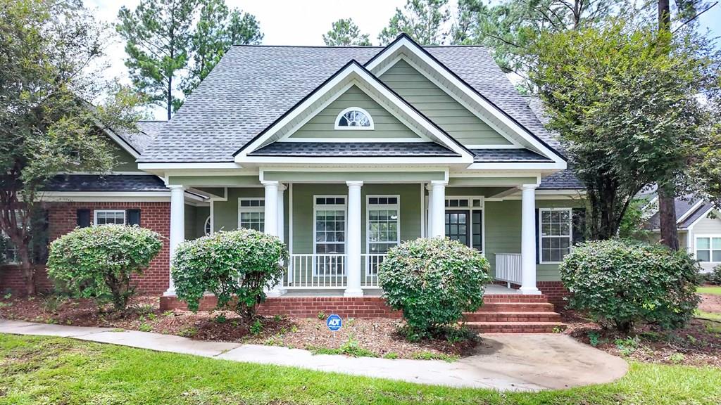 Some homes simply feel like home the moment you arrive, and 102 Spur Lane is one of them. Nestled on a beautifully landscaped .83-acre lot, this thoughtfully designed home offers the perfect balance of comfort, functionality, and timeless appeal. From the inviting front porch to the spacious backyard, every space encourages you to slow down and enjoy life. A new roof, new AC unit, and new septic system offer peace of mind. Inside, rich hardwood floors lead you through an open, welcoming layout designed for both everyday living and entertaining. The split-bedroom floor plan offers privacy, while the spacious primary suite provides a relaxing retreat complete with a luxurious tile shower, Jacuzzi garden tub, double vanities, and a generous walk-in closet. The kitchen is the heart of the home, featuring stainless steel appliances, abundant cabinetry, solid surface countertops, and a cozy breakfast area, while the formal dining room is ready for holidays and special occasions. Need extra flexibility? The upstairs fourth bedroom with a full bath is ideal for guests, a home office, or a private teen suite. Step outside to enjoy peaceful evenings on the back deck overlooking the backyard, or unwind on the welcoming covered front porch. With an additional storage building, plenty of outdoor space, and a location in one of Thomasville's most desirable neighborhoods, this is a home you'll enjoy for years to come.