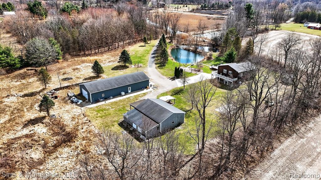 Hard-to-find 7-acre property offering privacy, versatility, and a setup you rarely see come to market. Tucked back with a pond and scenic views, this property delivers the space and functionality buyers are actively searching for.The raised ranch home features a walk-out basement, cathedral ceilings, and a wrap-around porch/deck overlooking the water—perfect for enjoying the setting year-round. Warm wood finishes and an open layout create a comfortable, inviting feel.The real value is in the outbuildings—two large pole barns, both temperature controlled, including a 30x80 barn with 12’ ceilings and large roll-up doors, plus a 30x30 secondary barn. Ideal for contractors, business owners, or anyone needing serious storage, workspace, or flexibility.All three structures are set up to operate together, with infrastructure in place for a shared boiler heating system and generator backup capability—giving this property a level of efficiency and utility that is extremely difficult to replicate.Properties offering this combination of land, privacy, and functional outbuildings rarely become available. Conveniently located just minutes from US-127.