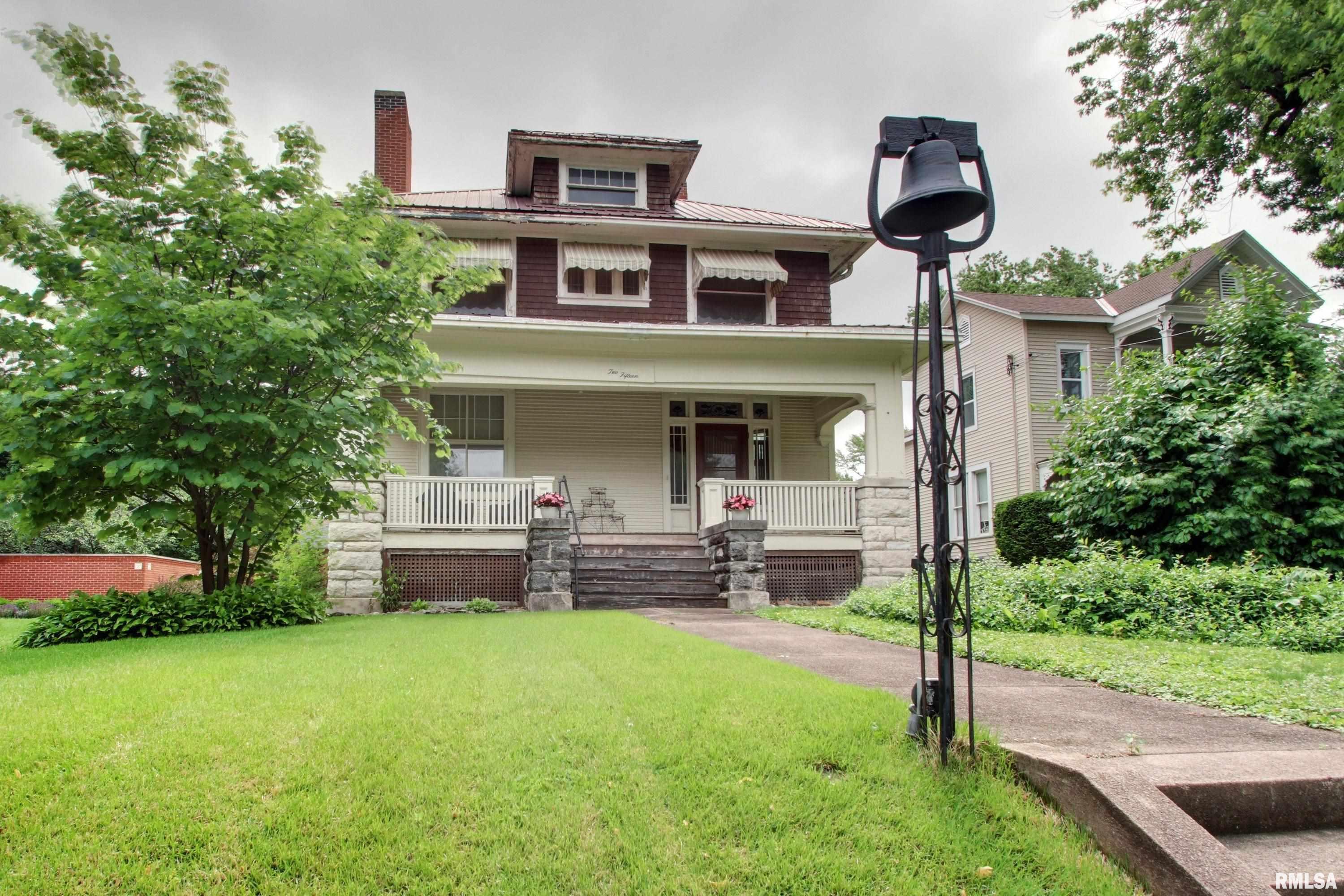 Charming 2-story home located in the Historic District featuring beautiful hardwood floors, stunning original woodwork, functional pocket doors, beamed ceiling & a gorgeous open staircase that welcomes you from the inviting entryway.  Perfect place for the Christmas tree!  Major updates include new furnace & central air in 2025, some updated plumbing and electrical improvements. Outside, enjoy a nice driveway and retaining wall (approx. 6 years old) leading to a 2-car detached garage and backyard. A wonderful blend of character, charm and important updates!